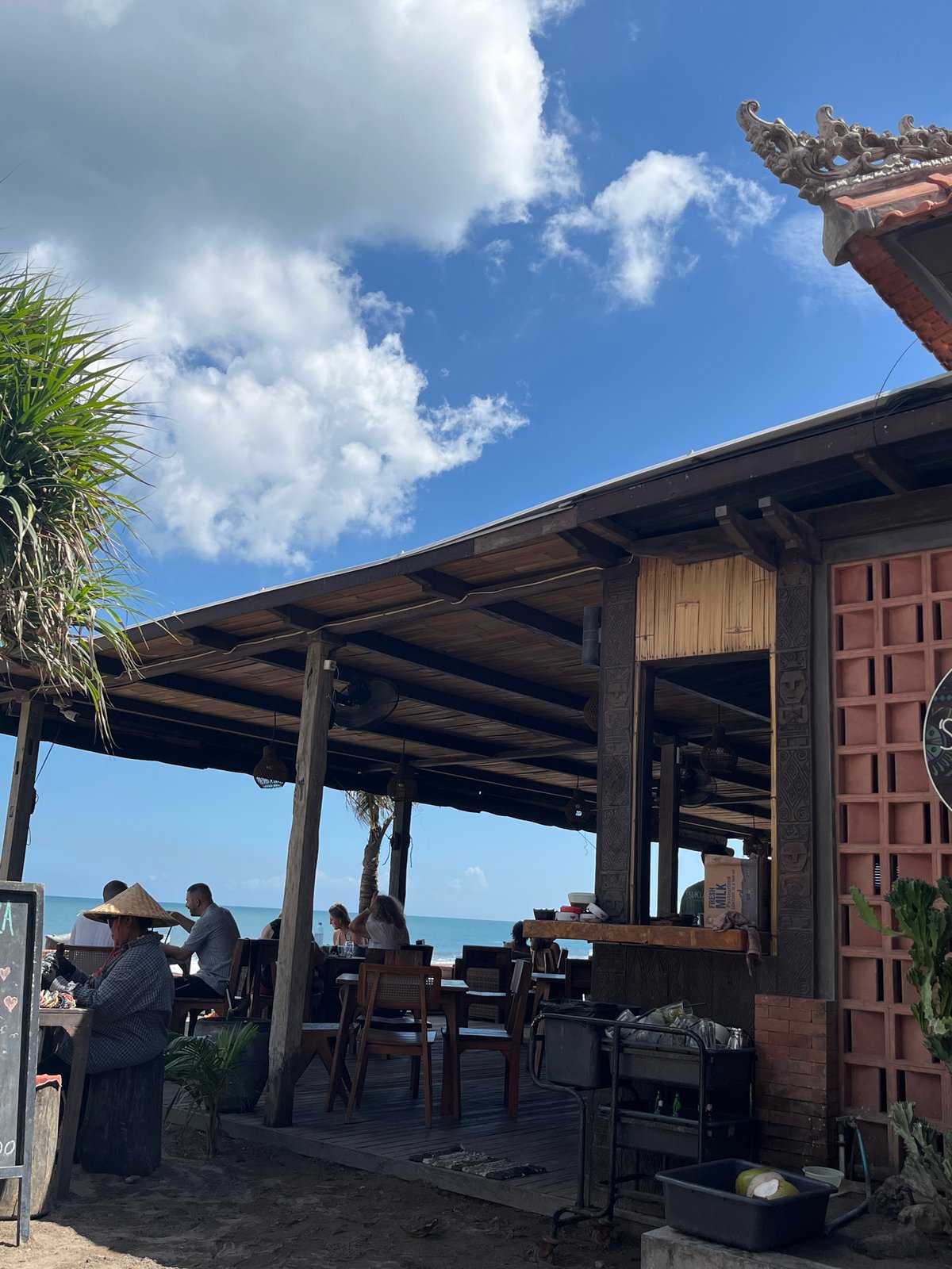 Beachside dining scene documented in North Kuta with warning flags