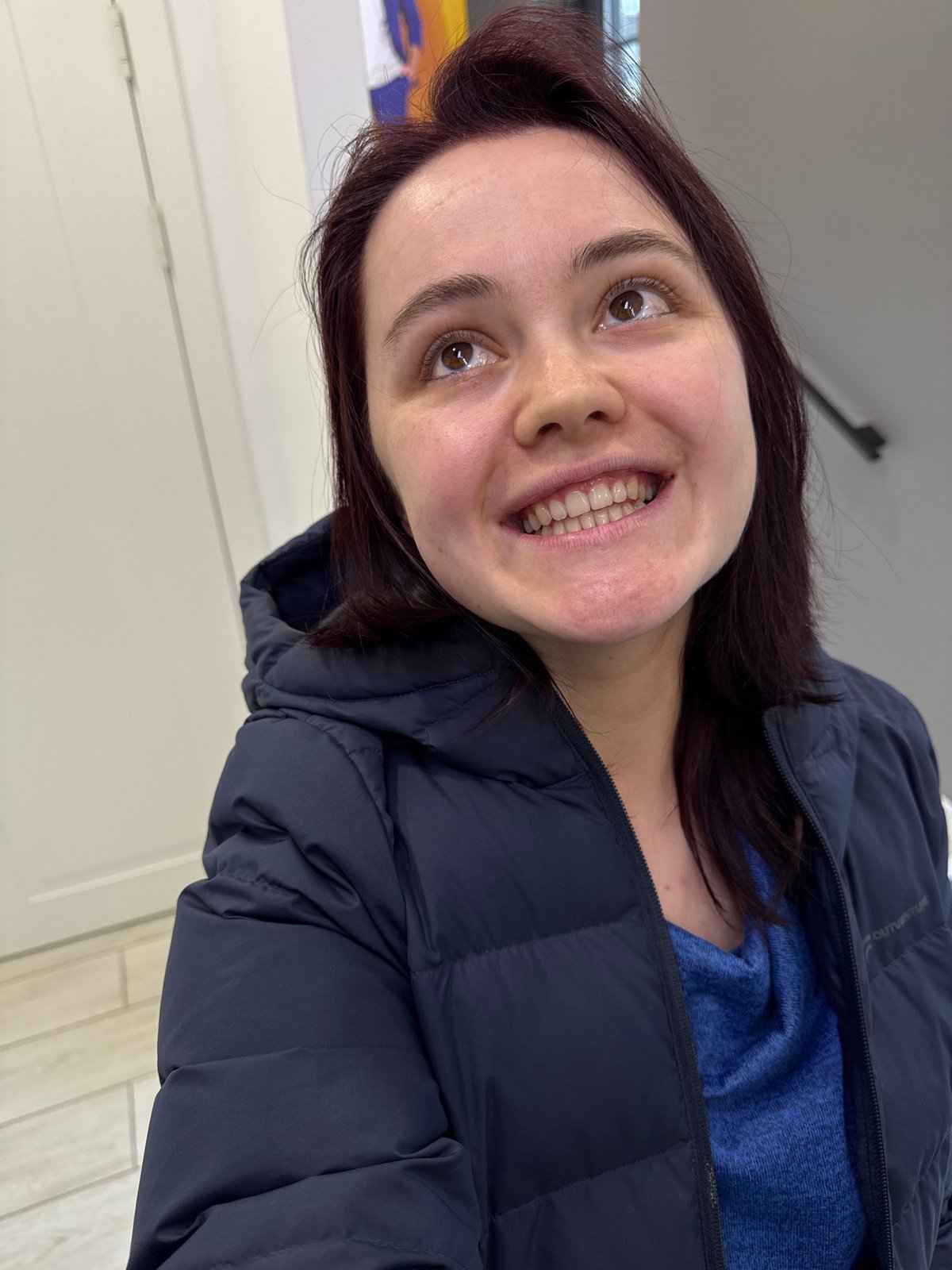 Woman in blue jacket photographed smiling in Izhevsk