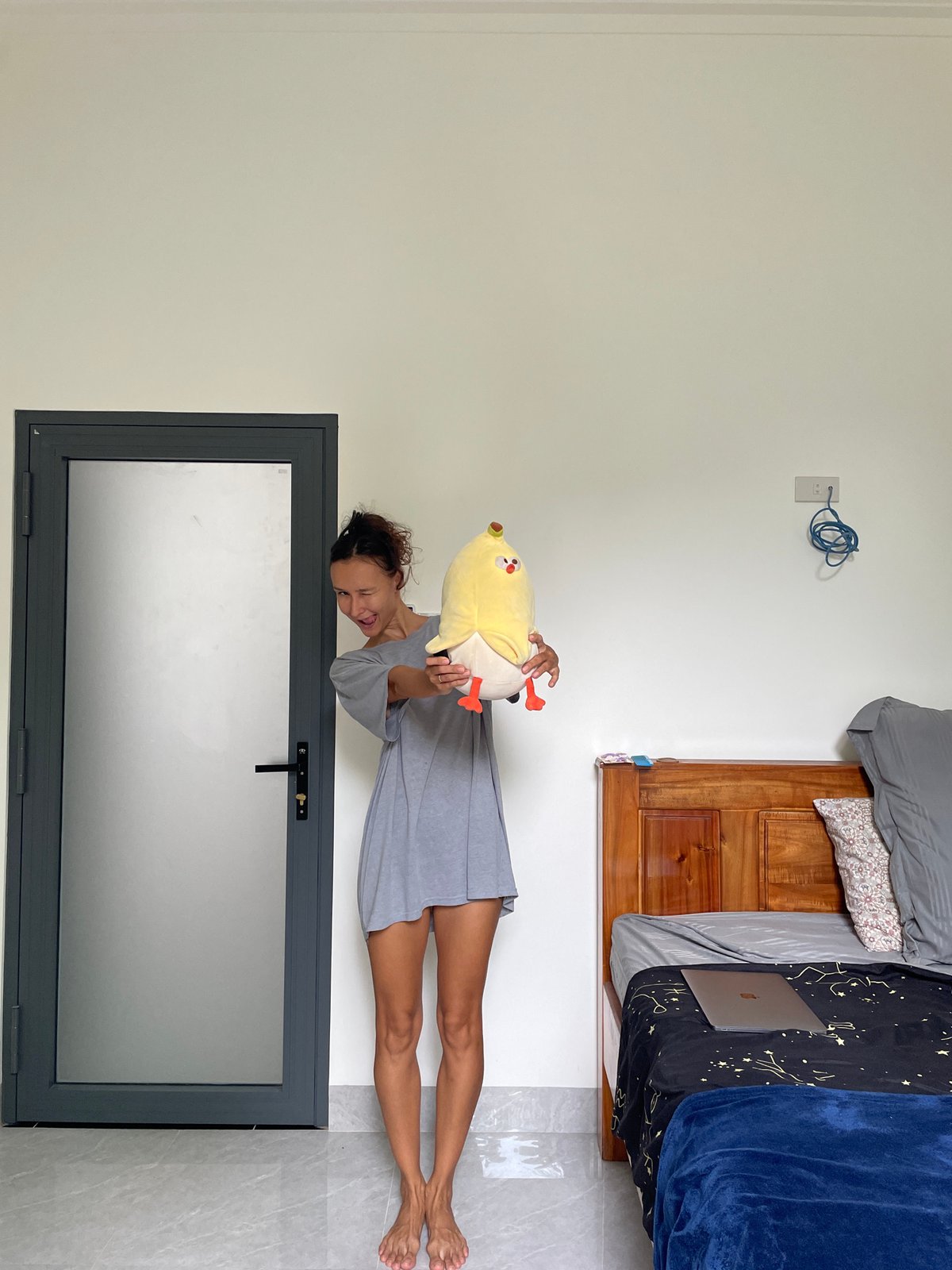 Woman poses, exercises in Mũi Né bedroom during morning session