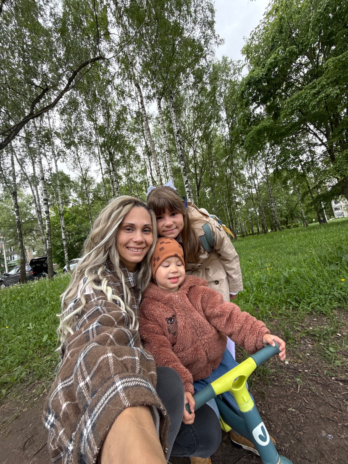 Woman and children enjoy outdoor moment in Rusanovo park
