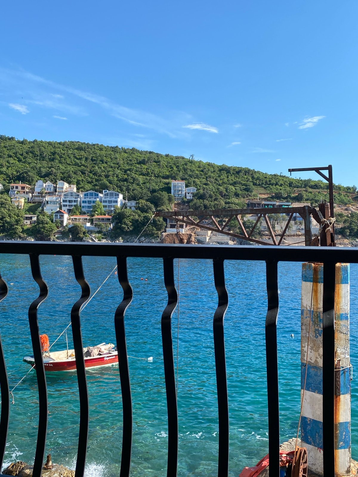 Woman enjoys quiet moments with cat on Adriatic balcony