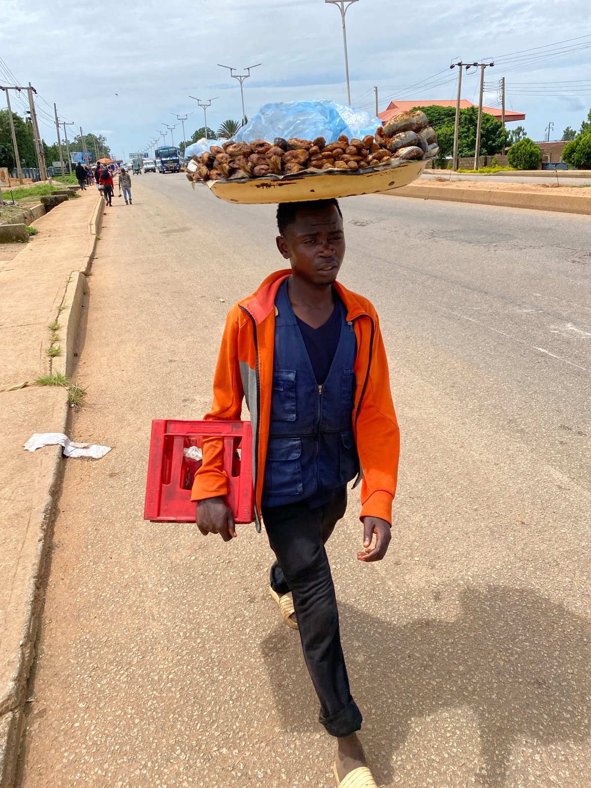Afternoon foot traffic and street commerce in Bukuru, Nigeria