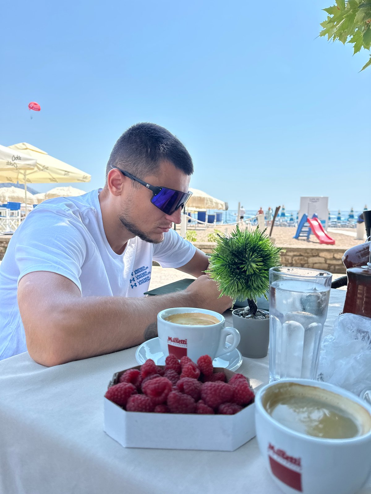 Lazy beach morning in Boreti with coffee, sun, and paragliders