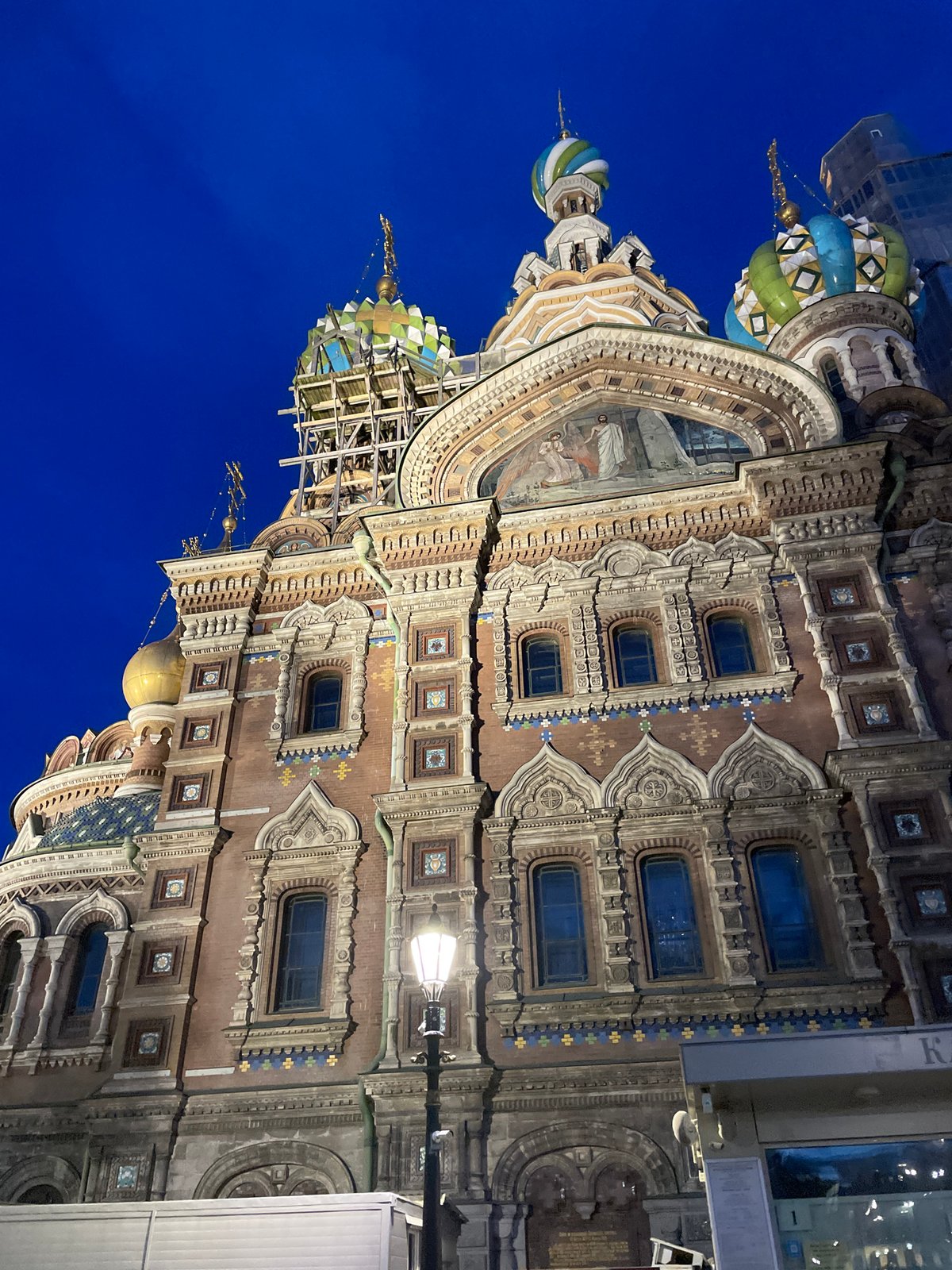 Street musician performs near Russian cathedral at twilight