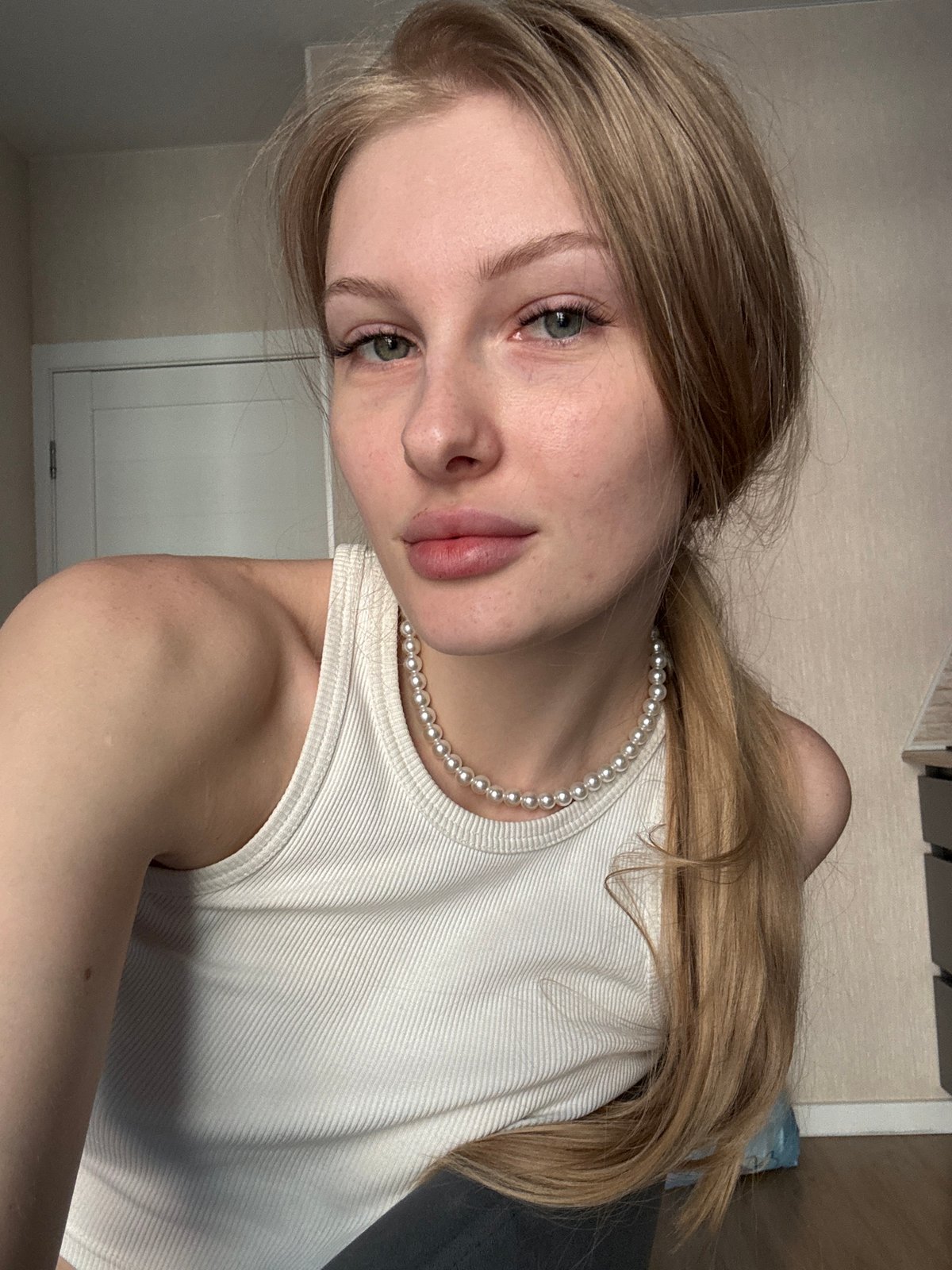 Young woman takes multiple selfies indoors in Perm, Russia