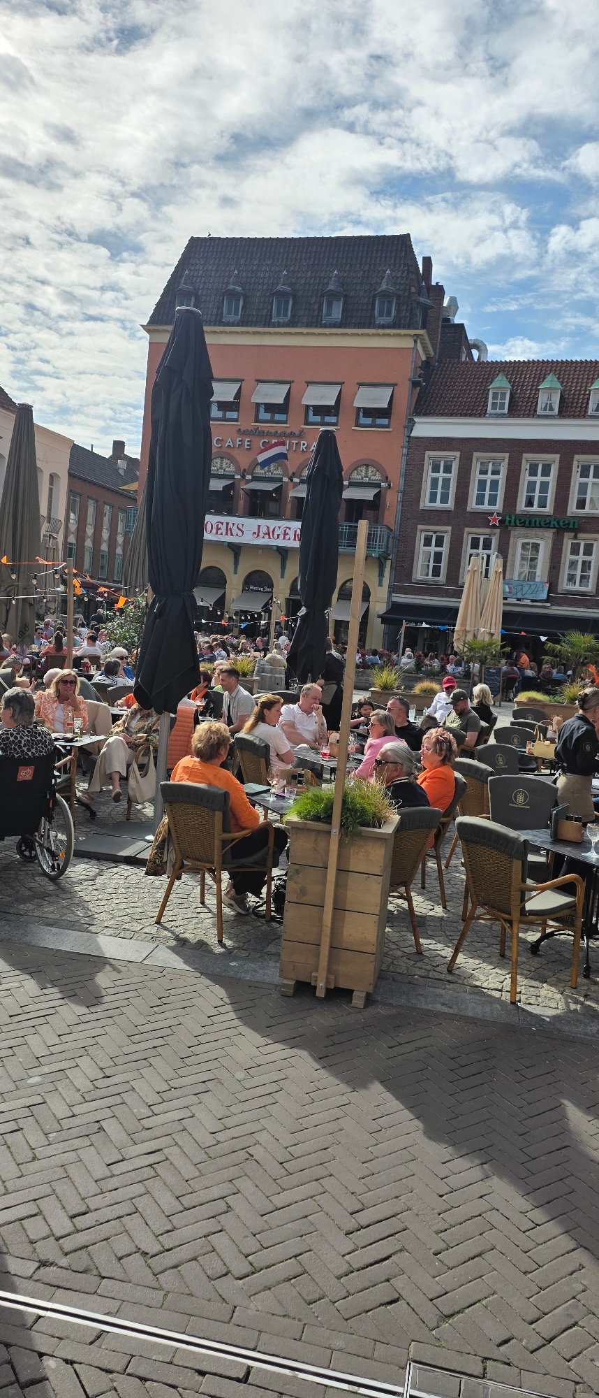 Busy outdoor cafe terrace observed in Venlo, Netherlands