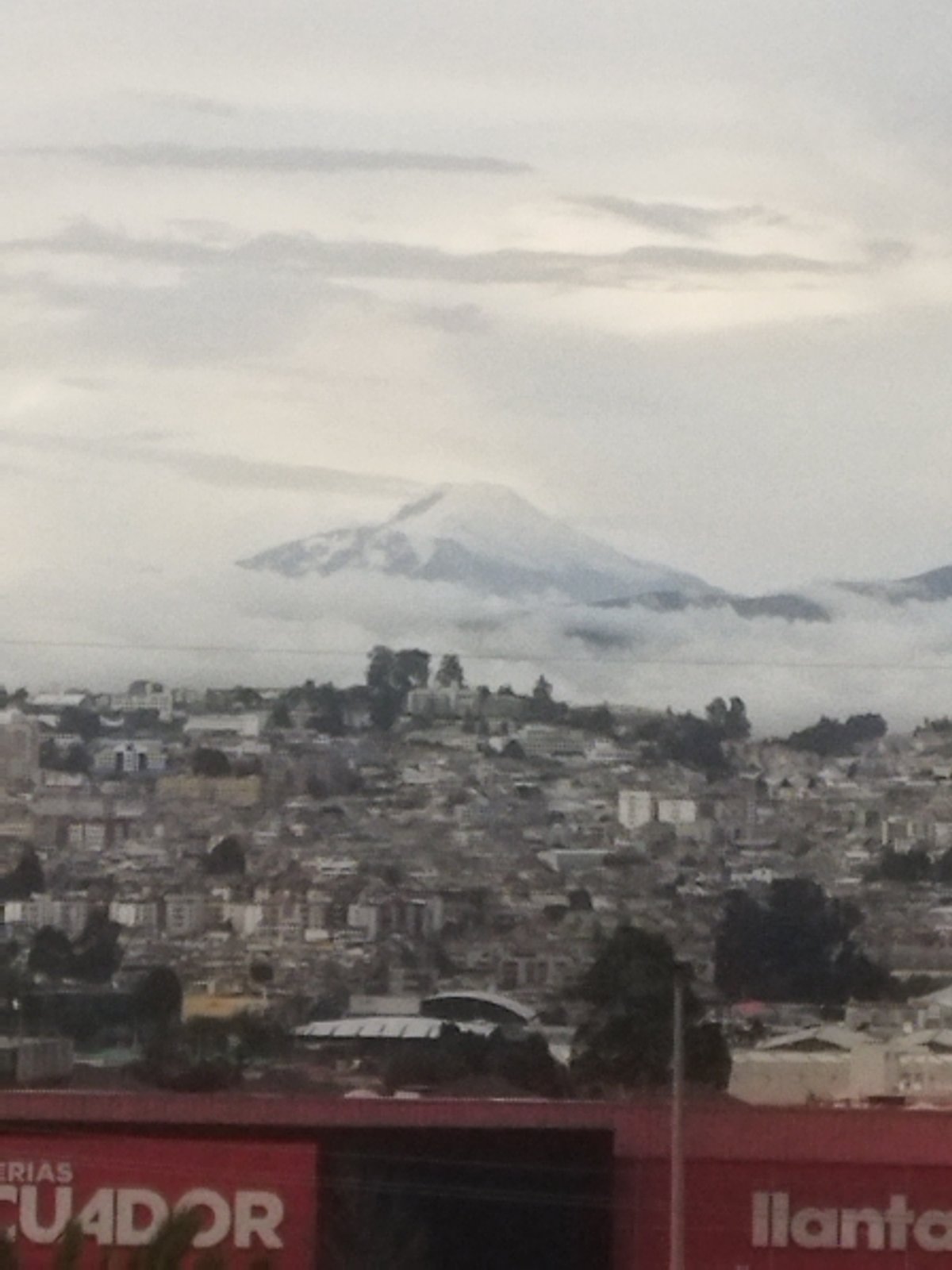 High-rise construction documented against mountain cityscape backdrop