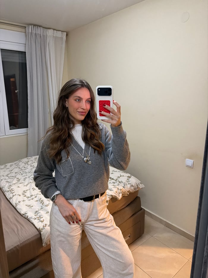 Woman takes selfies, relaxes indoors in Budva with dog