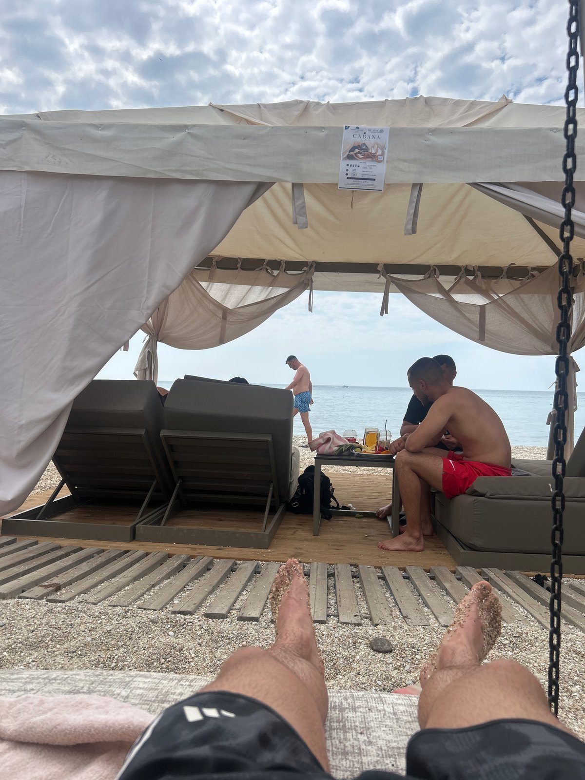 Lazy beach cabana morning, sunglasses on, drinks out.