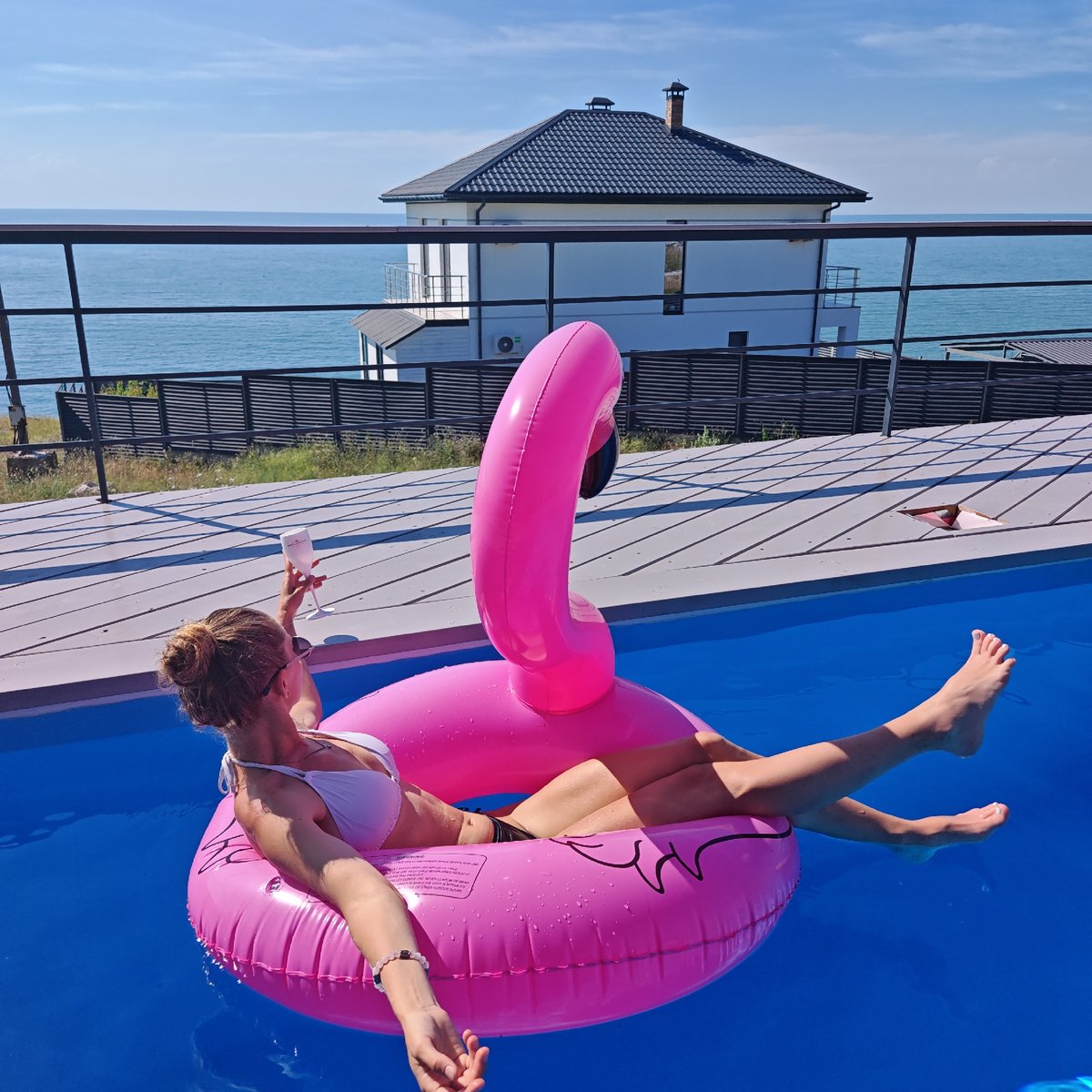 Poolside afternoon on a pink flamingo float