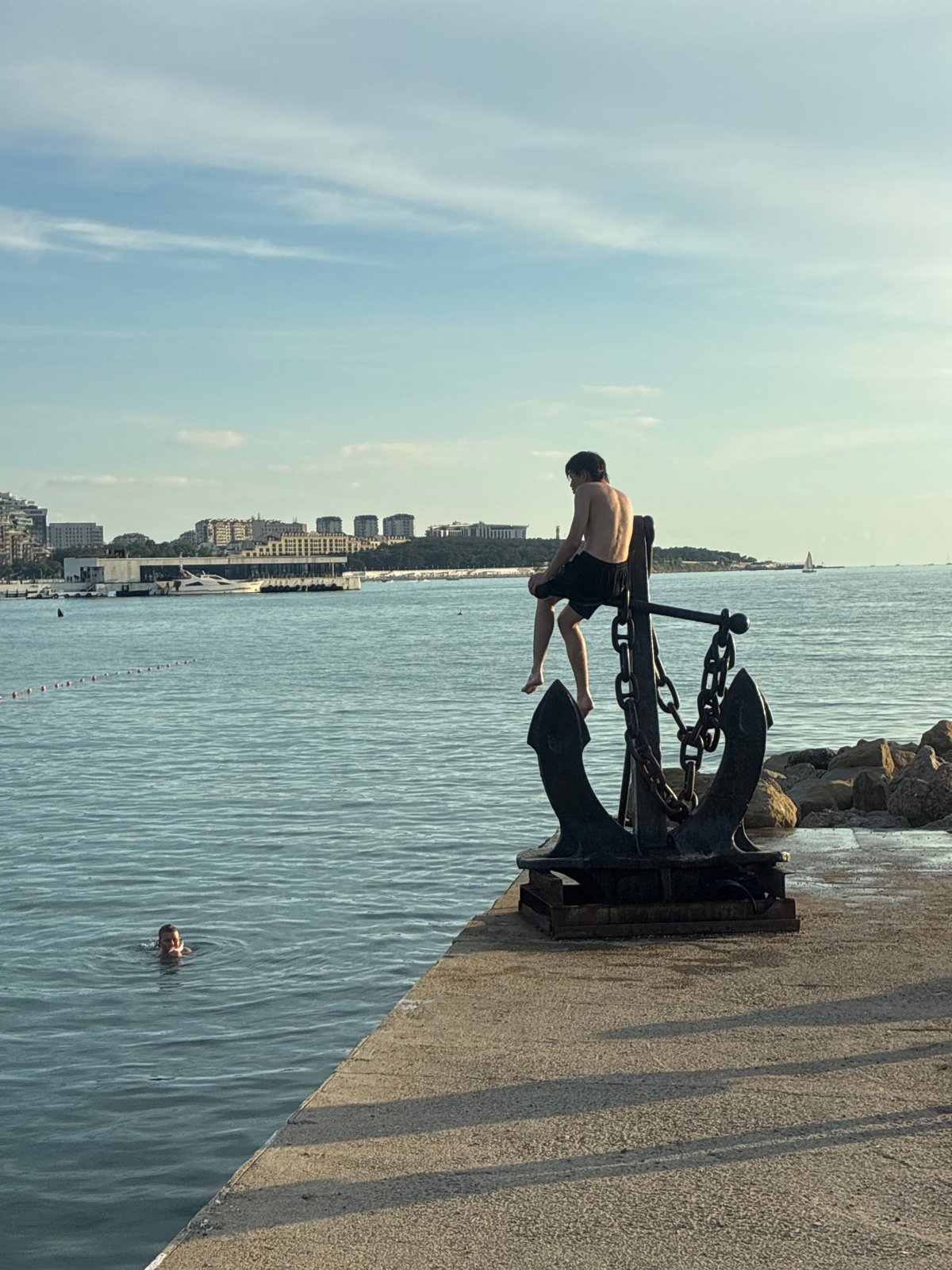 Evening promenade life in Gelendzhik with street performers and beachgoers