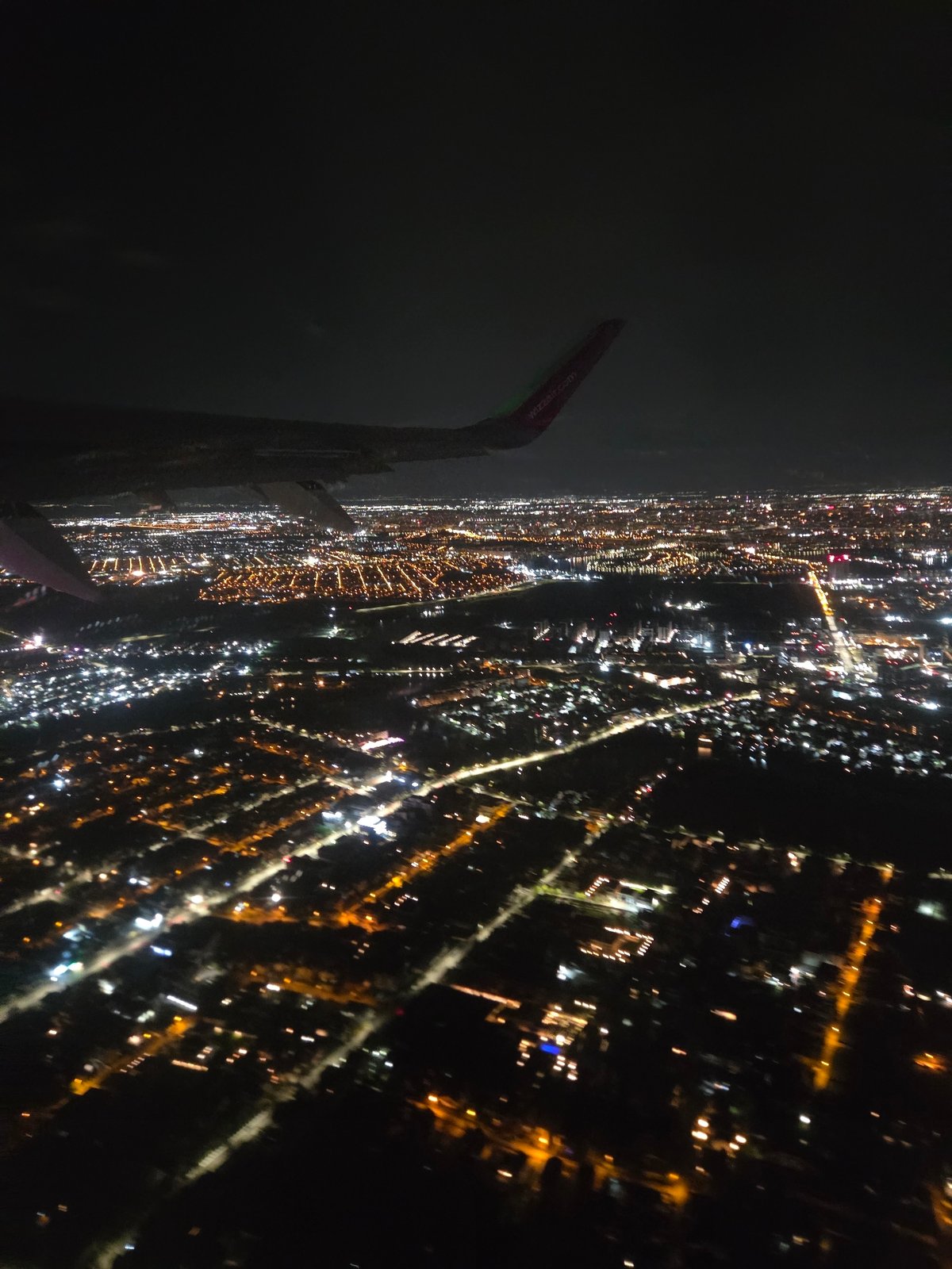 Nighttime aerial view captures illuminated Voluntari cityscape