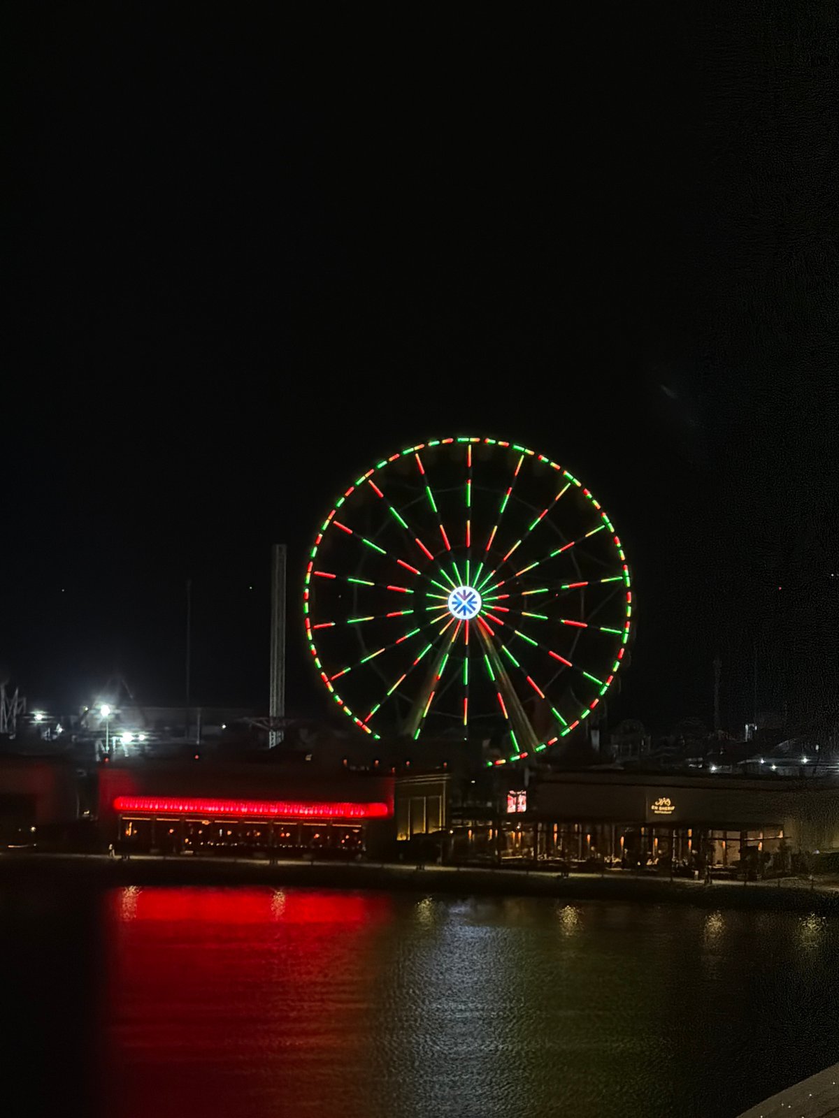 Evening drive through a lit-up Middle Eastern city waterfront