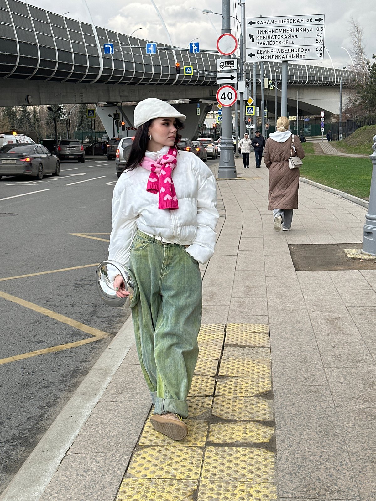 Woman in colorful outfit spotted near parked vehicles in Moscow