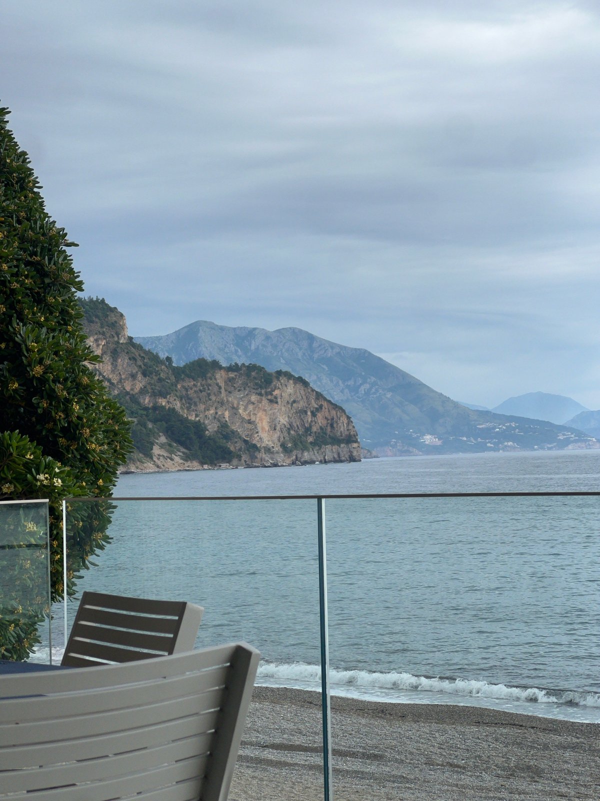 Woman photographs beach visit from Montenegro terrace