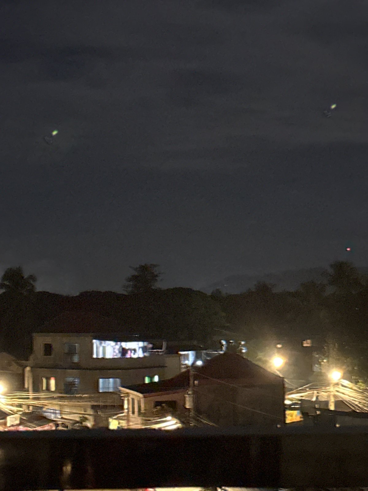 Moonlit night over Davao City's rooftops with a glowing skyline