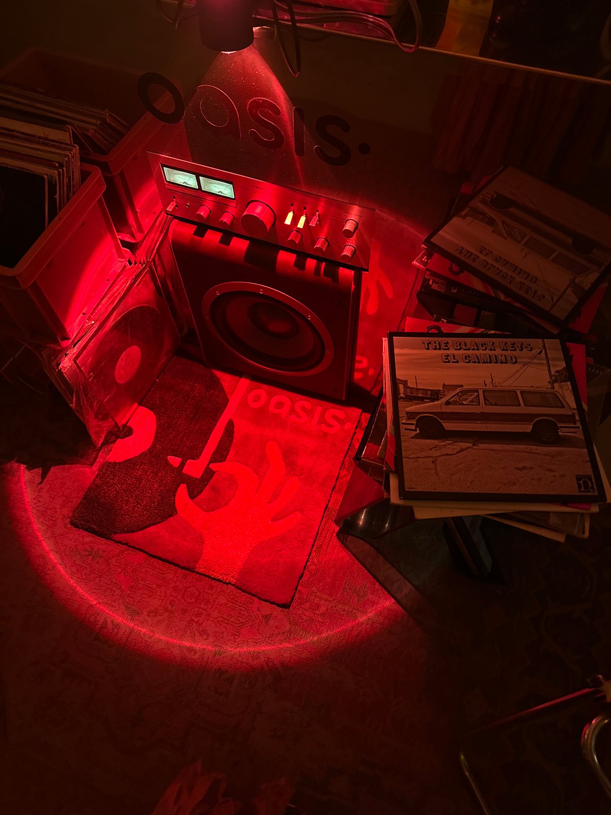 Vinyl collection documented under red lighting includes Black Keys album