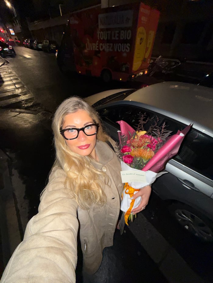 Woman buys colorful bouquet, takes selfies at Paris flower shop