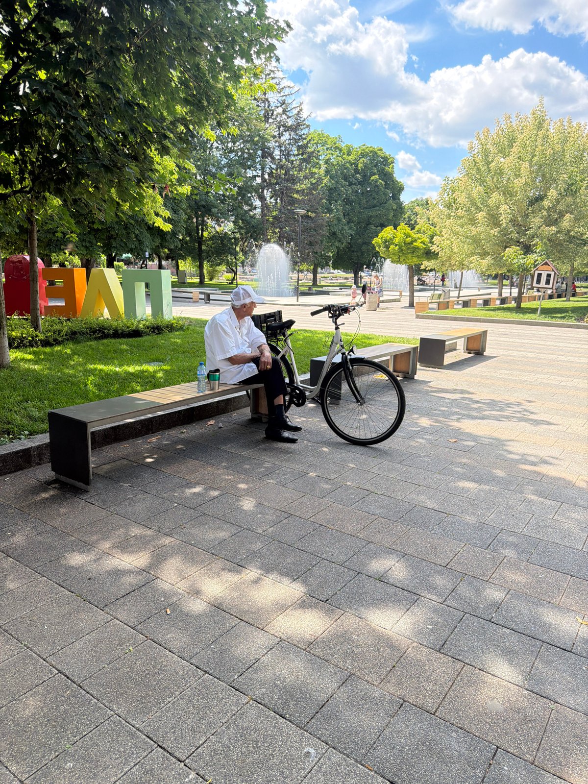 Afternoon in a Pleven park: bench, bike, and fountain