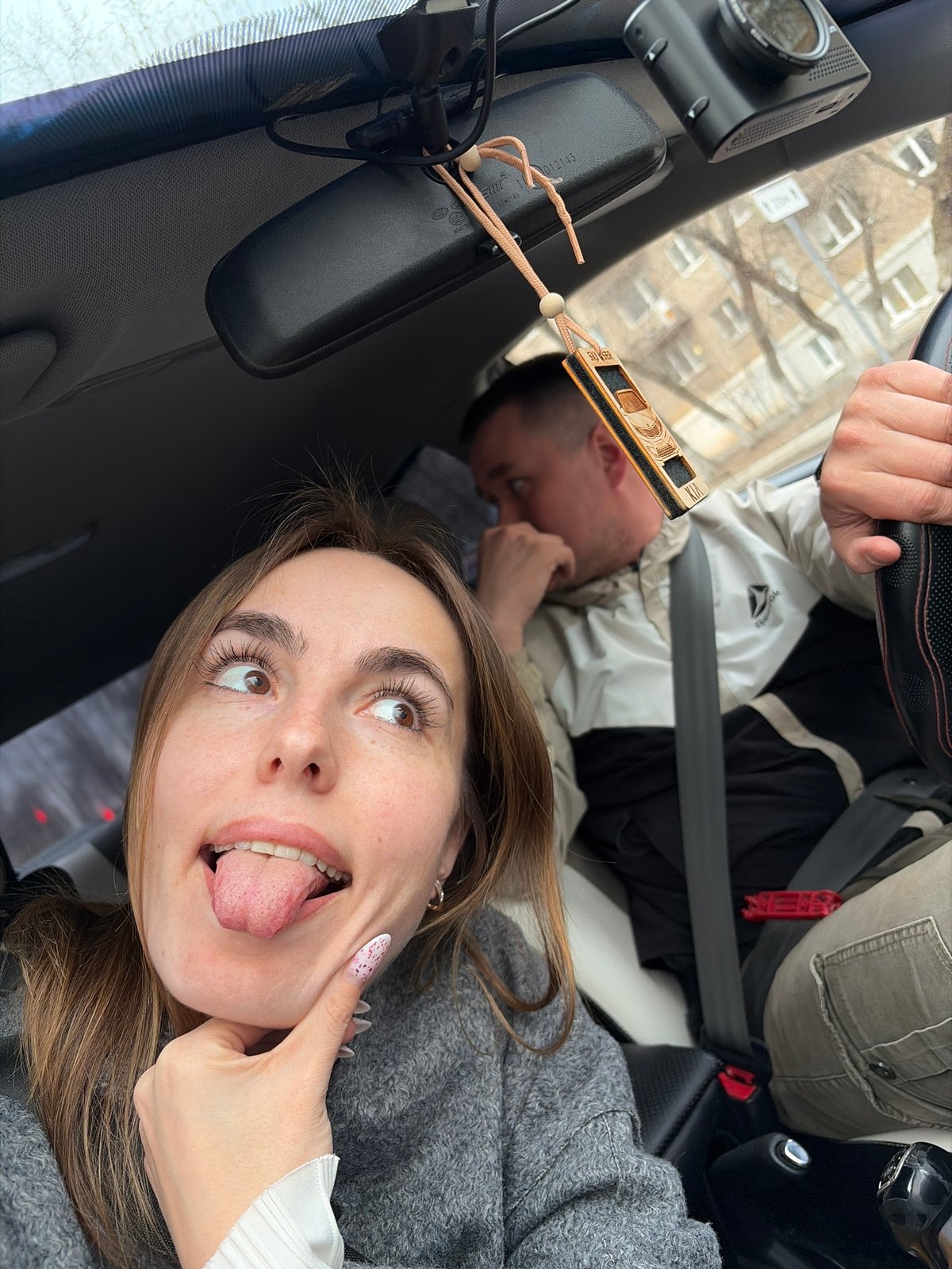 Two people photographed in car during Izhevsk city drive
