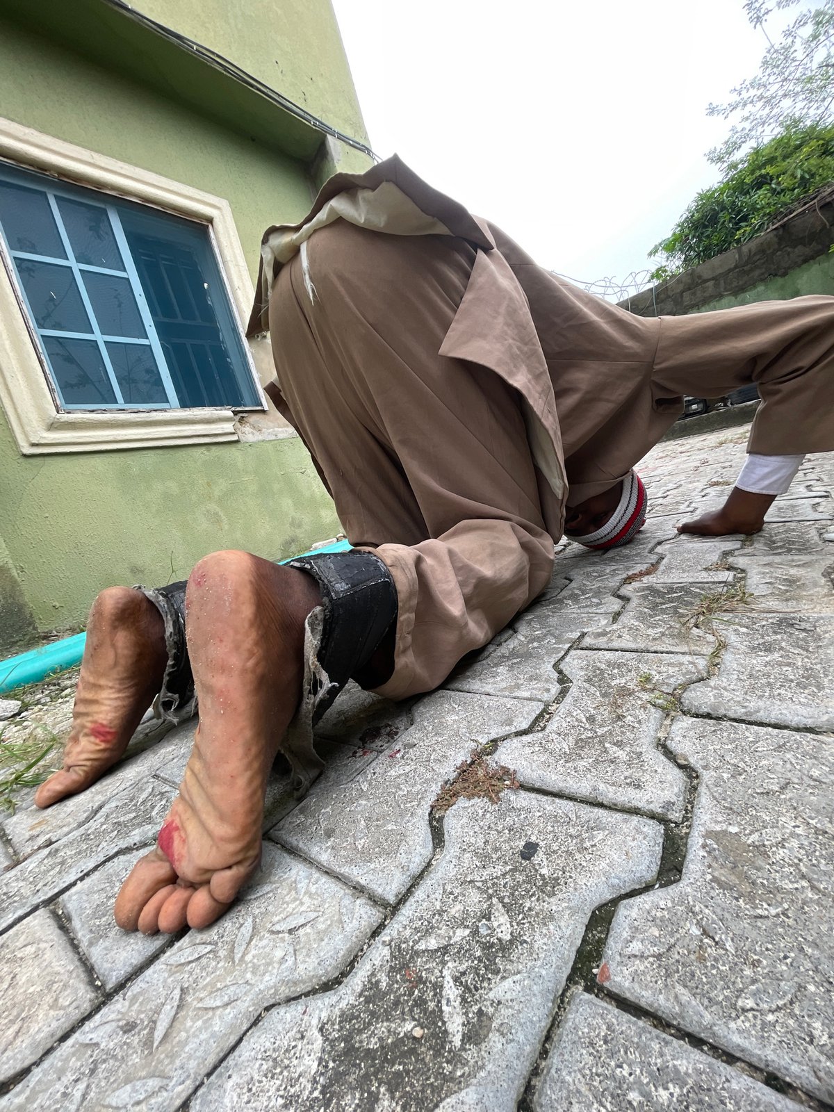 Man in striped hat documented across Ado, Nigeria