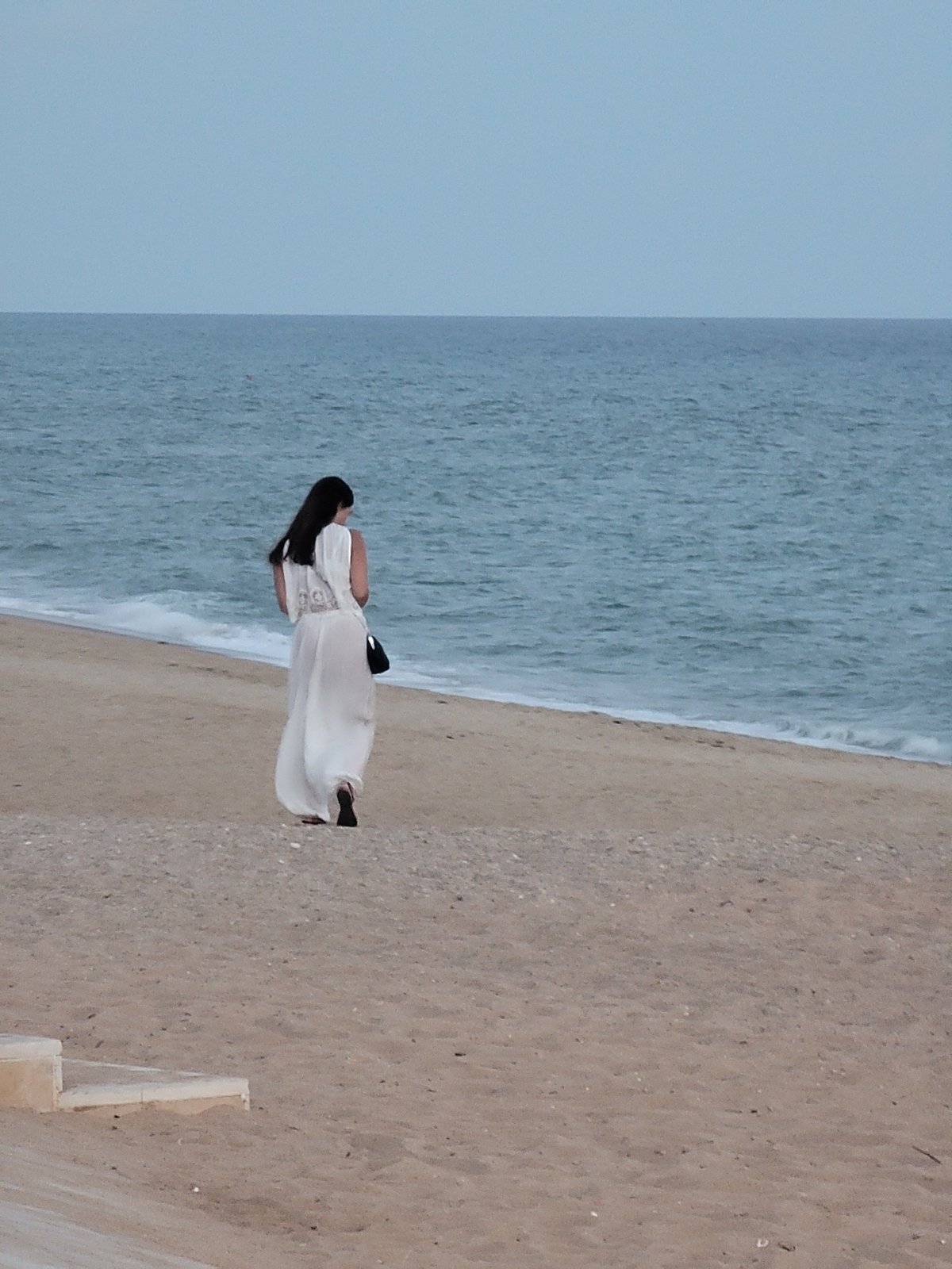 Quarteira beachfront at dusk: promenade life, street performance, summer evening