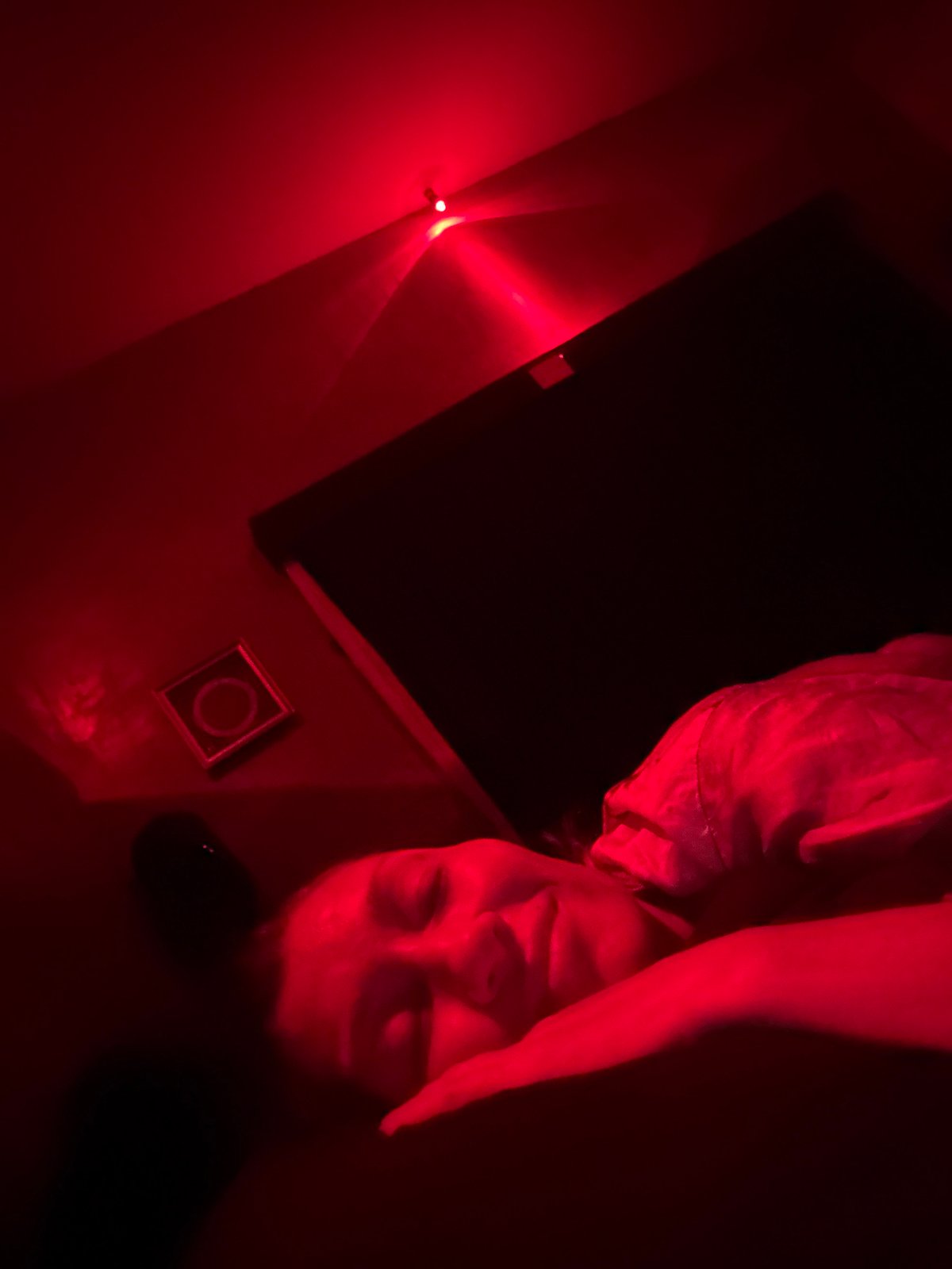 Red-lit indoor scene captured in Mengwi, Indonesia