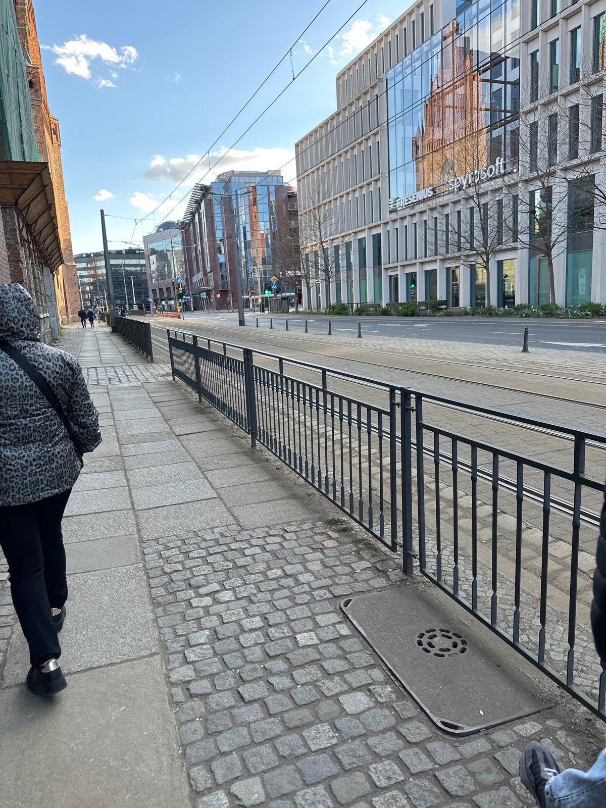 Tourists photograph famous bronze dwarf statues in central Wrocław