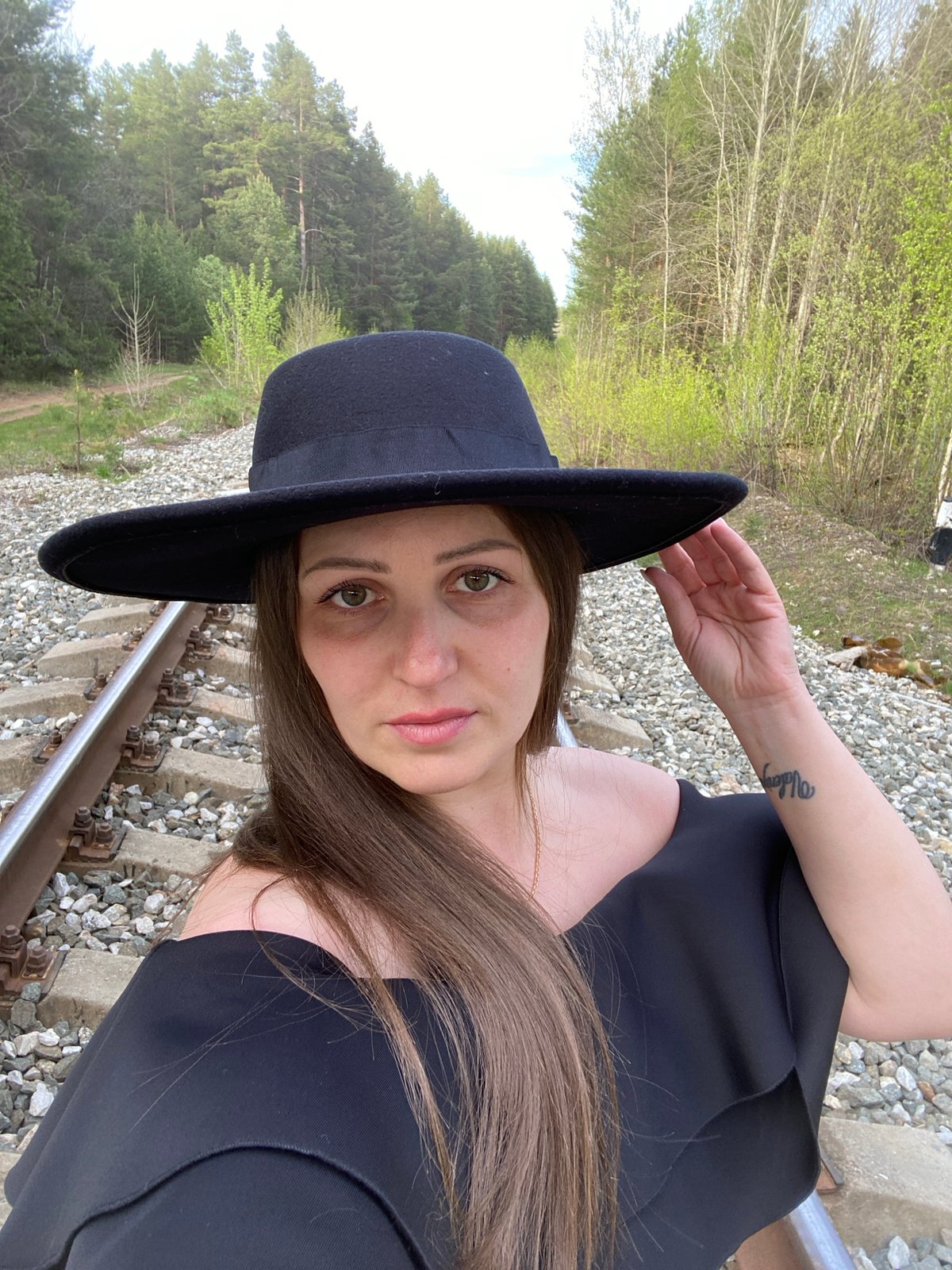 Woman poses on railway tracks in Chaikovsky, Russia