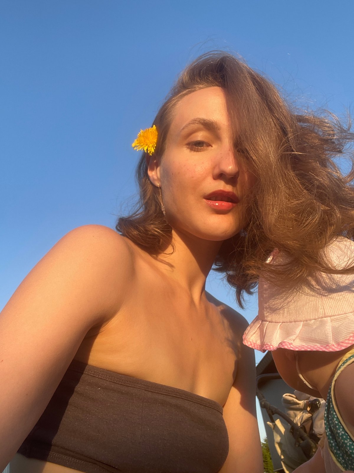 Woman poses with dandelions in outdoor photo session, Russia
