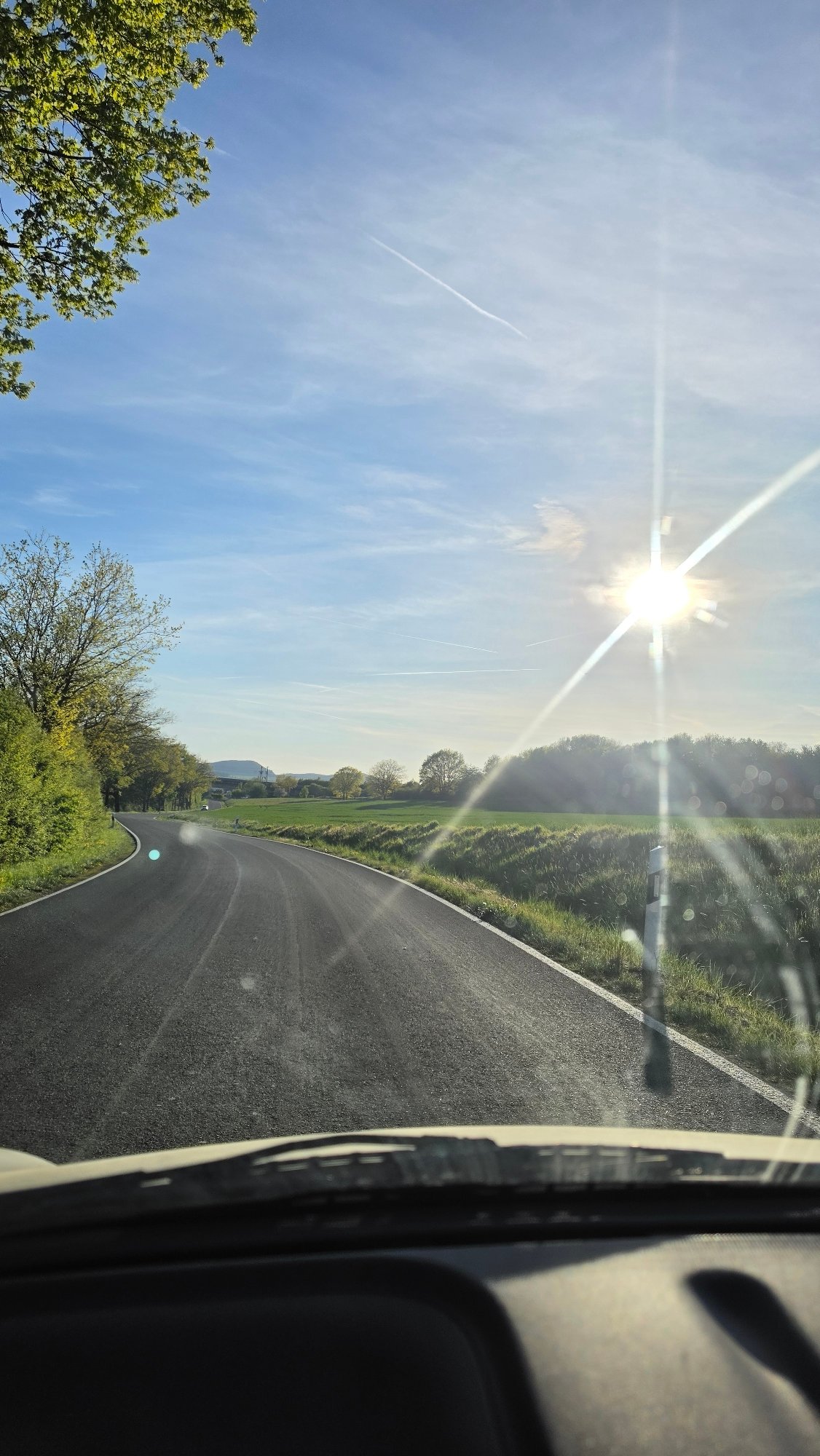 Driver captures sunlit countryside view on German roadway