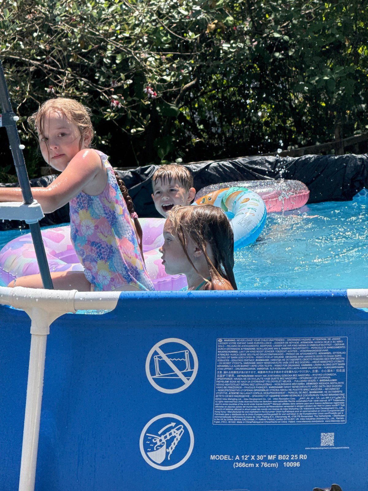 Kids' pool day in a Sochi backyard, summer morning