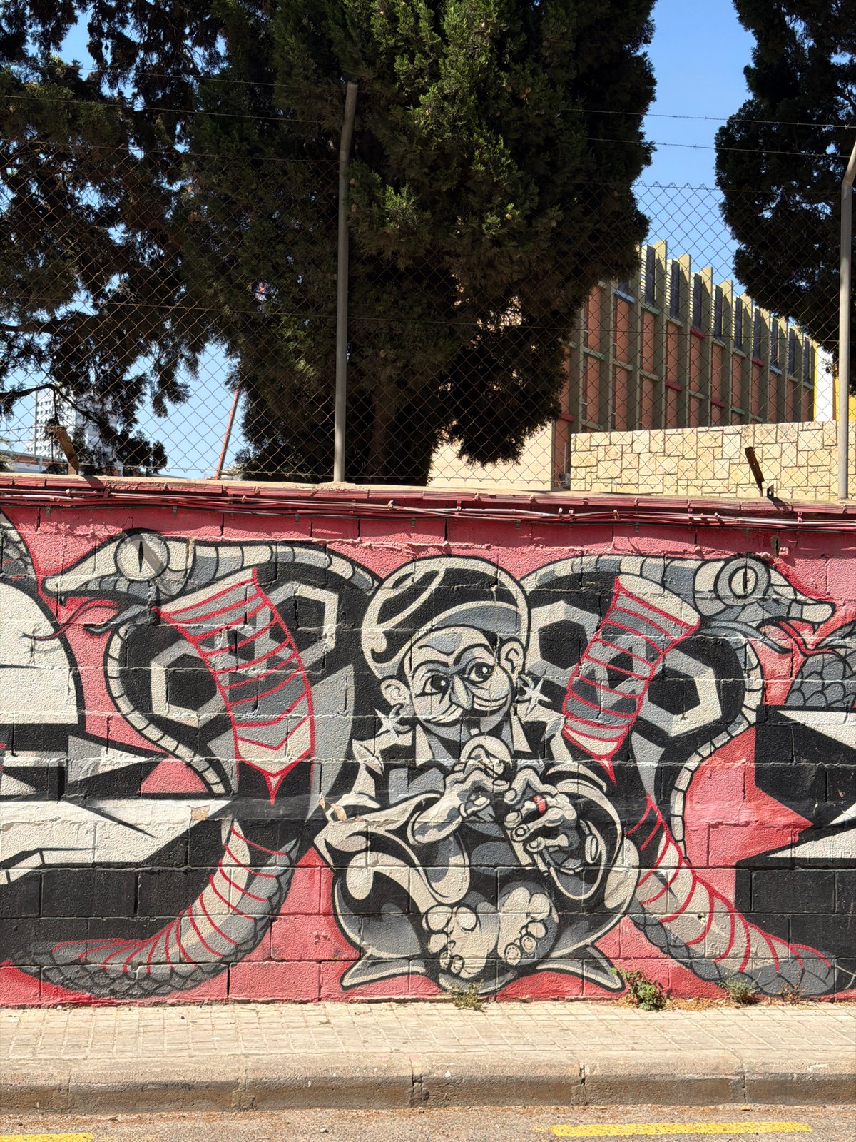 Street murals, scattered scooters, and soccer gear in an urban neighborhood