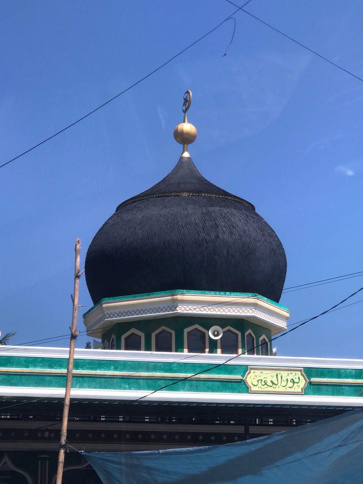 Mosque with distinctive dome and striped minaret observed in Lhokseumawe