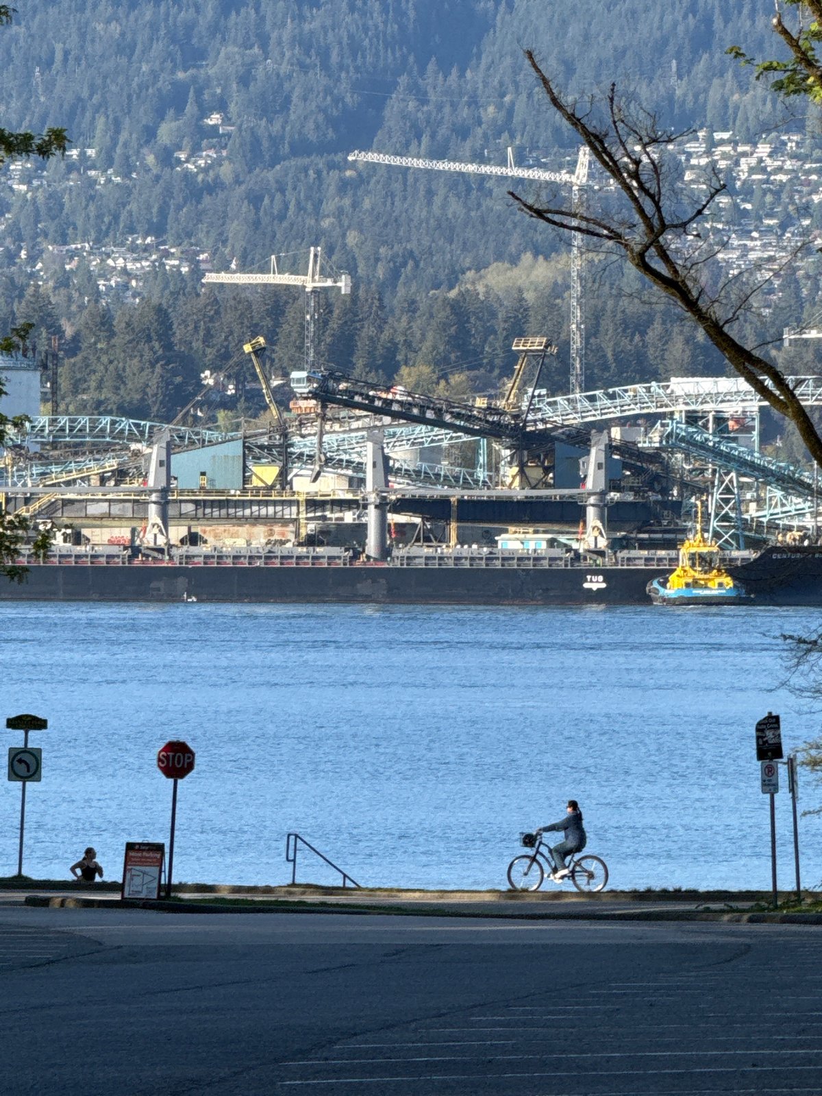 Cargo ship docked at Vancouver port with industrial infrastructure