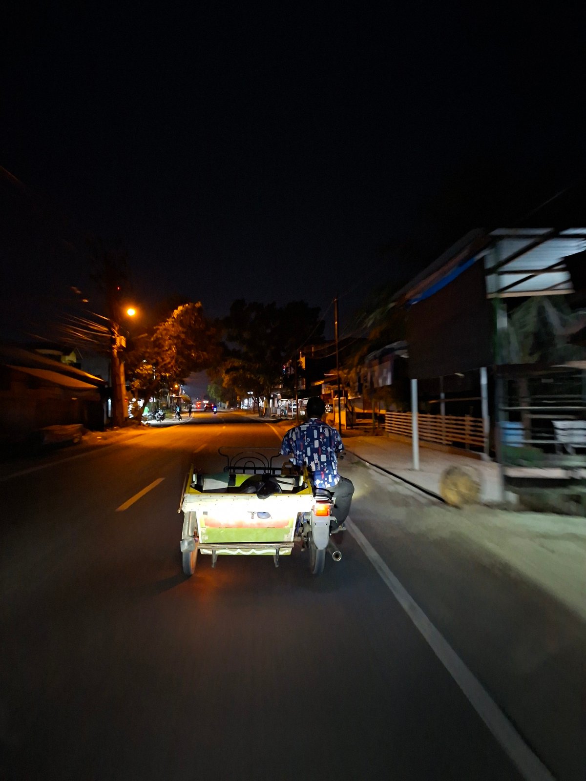 Evening motorcycle rider captured on Lhokseumawe streets