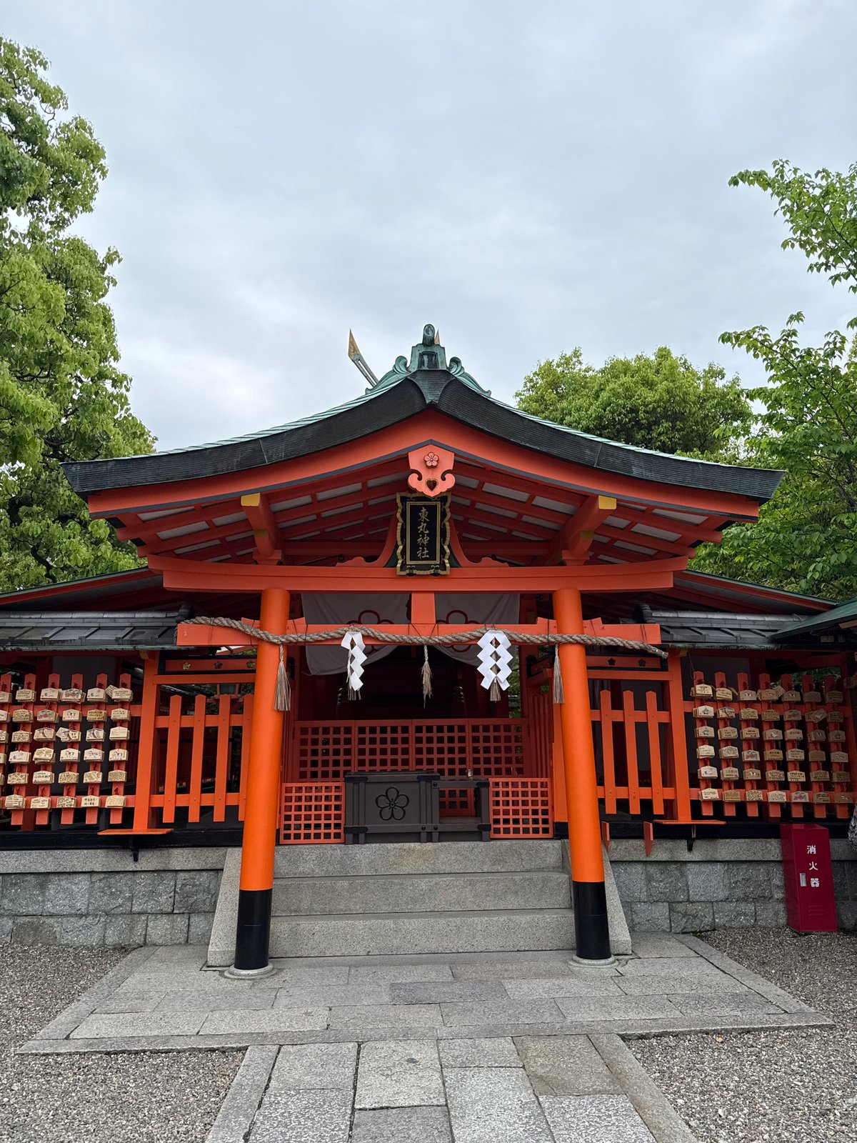 Visitor documents traditional elements of Fushimi Inari Shrine, Kyoto