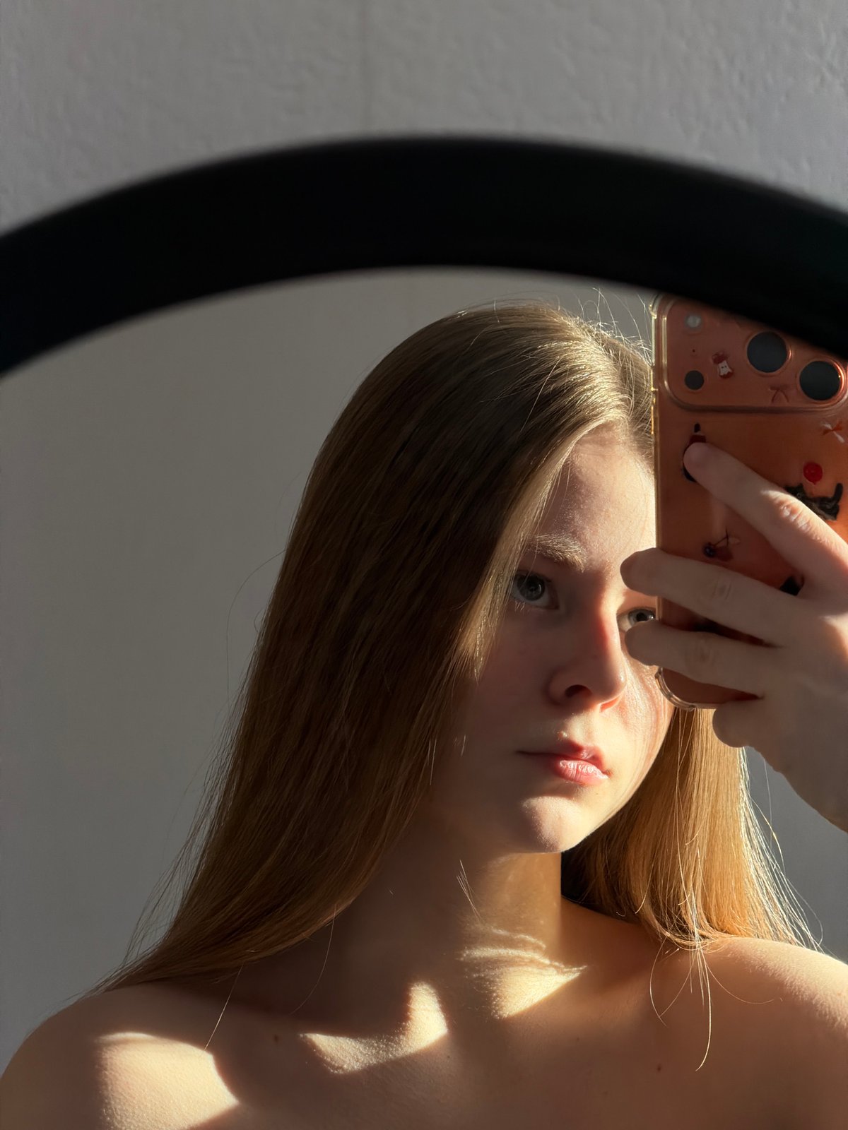 Woman documents hair-drying routine through selfies in Perm bedroom
