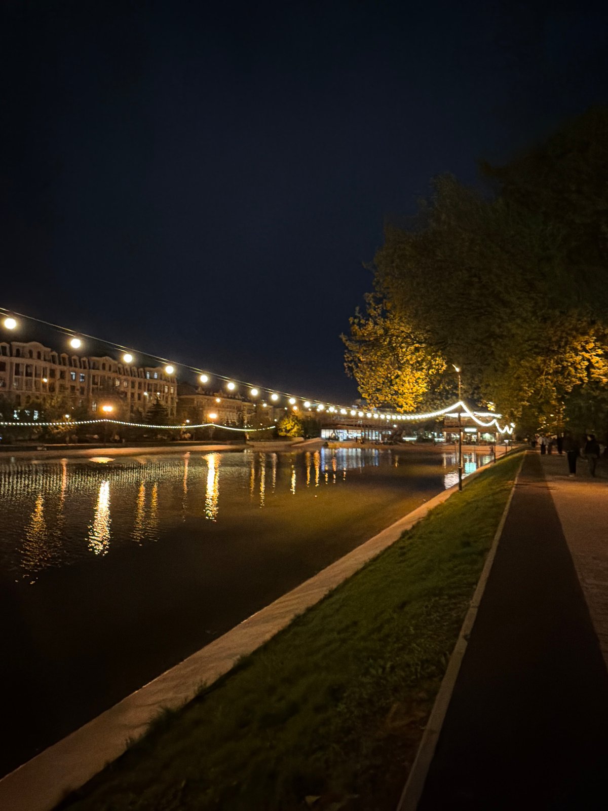 Evening stroll captured along illuminated Kazan canal walkway