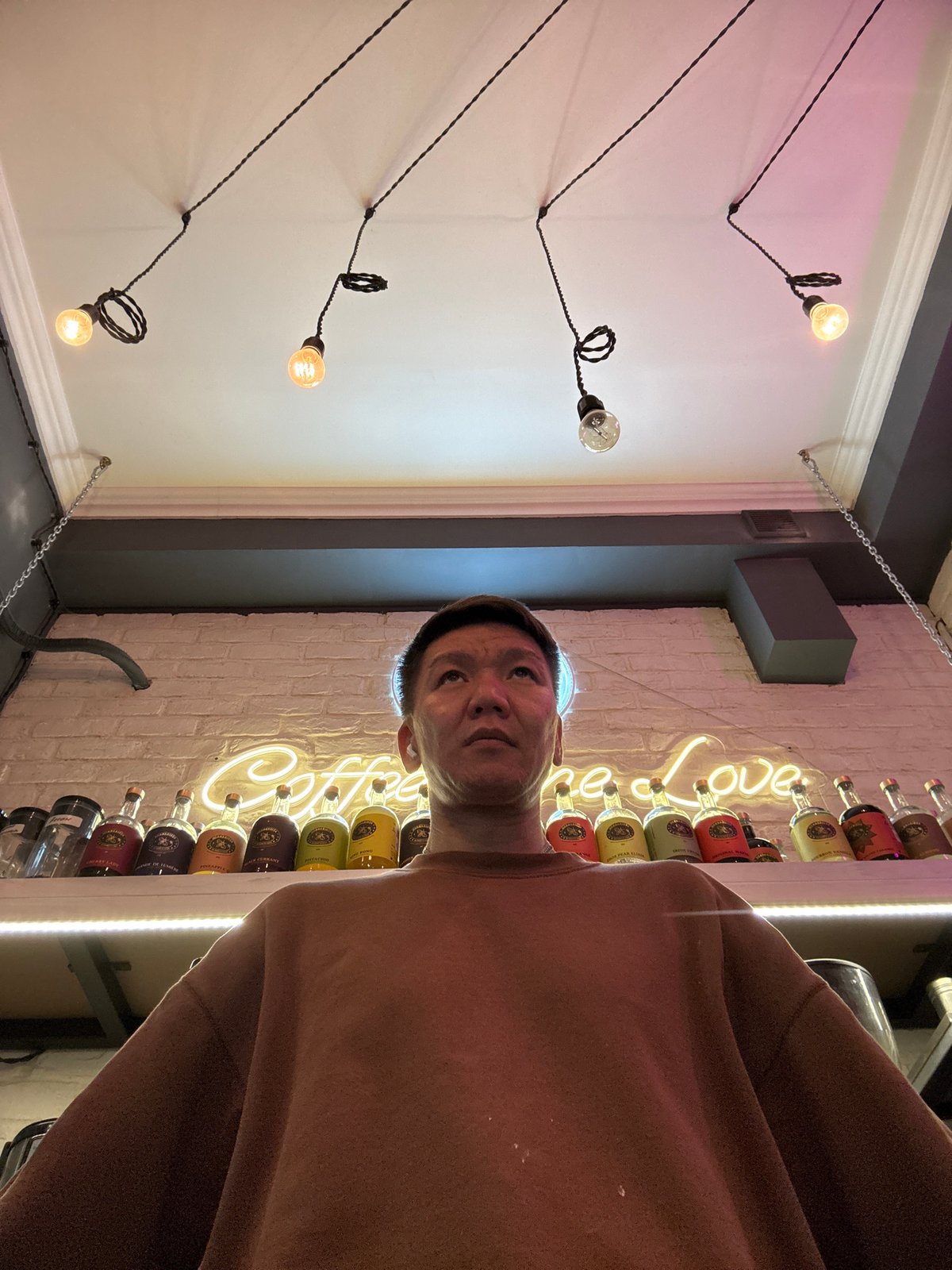 Selfies at a cozy Moscow café with neon signage