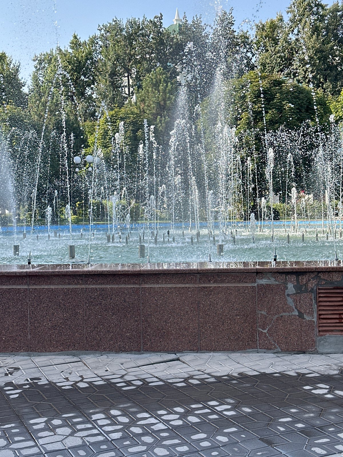 Afternoon at a busy fountain in a Tashkent city park