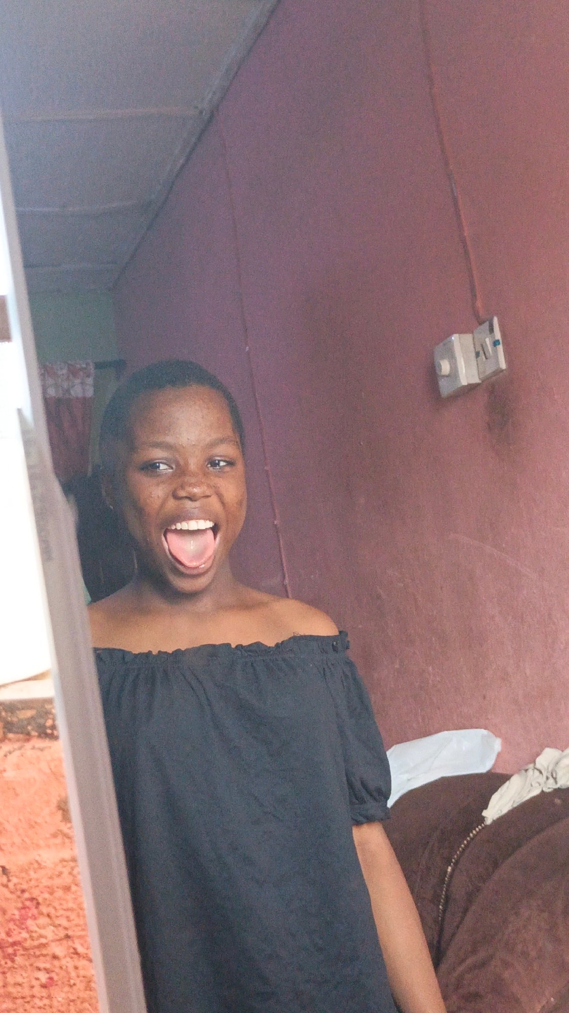 Woman displays playful expression in doorway