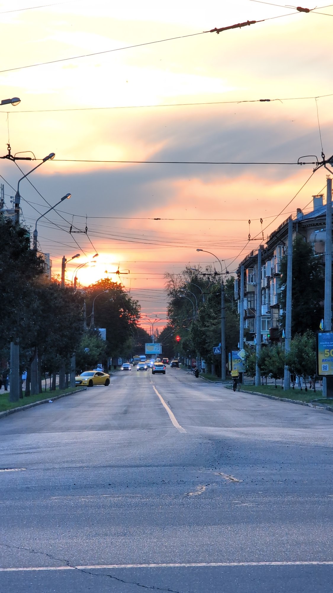 Summer evening street life in an Eastern European city at sunset