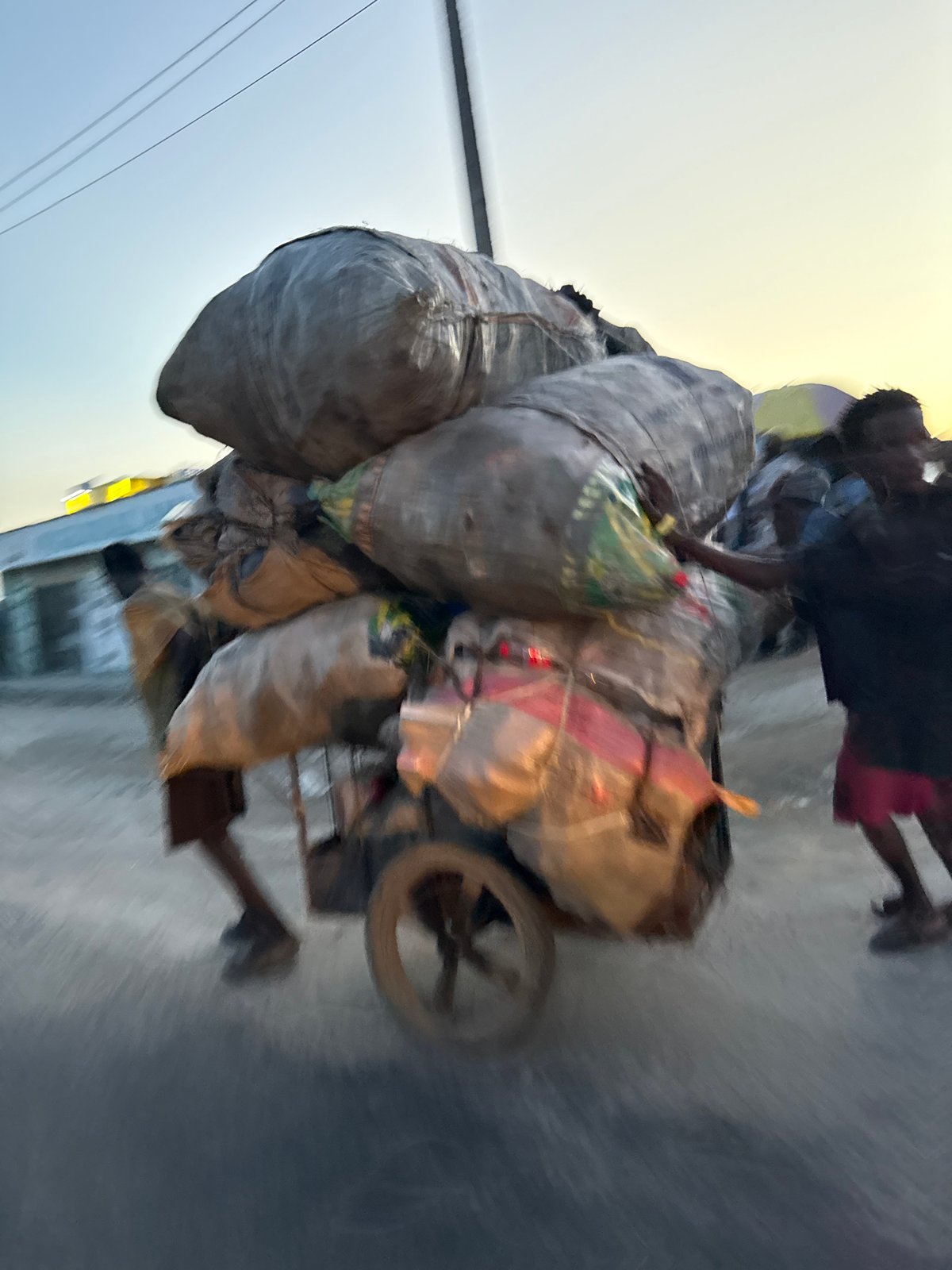 Heavy cargo cart rolling through the streets of Ado, Nigeria