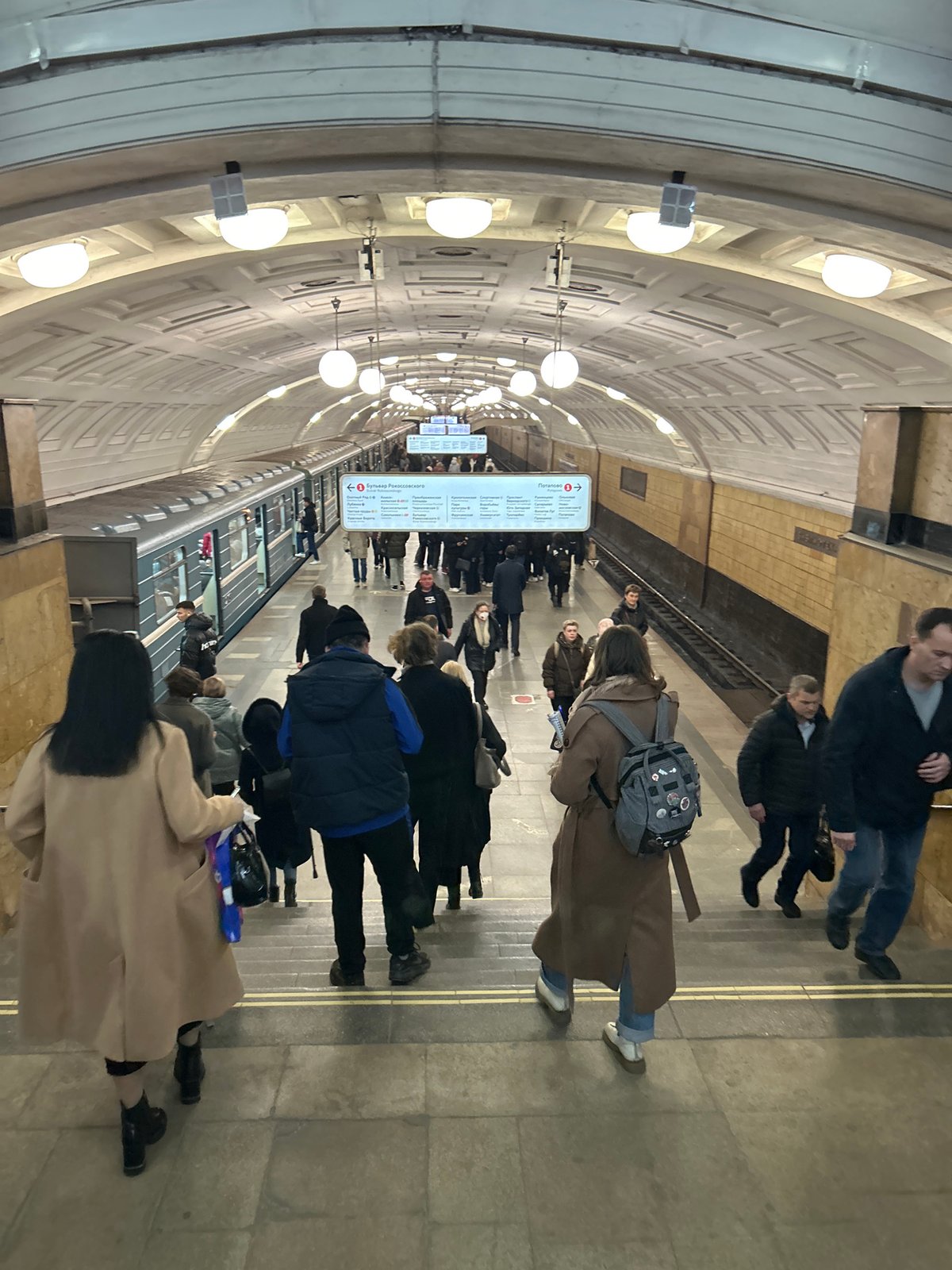 Moscow metro passengers wait on crowded platform during midday