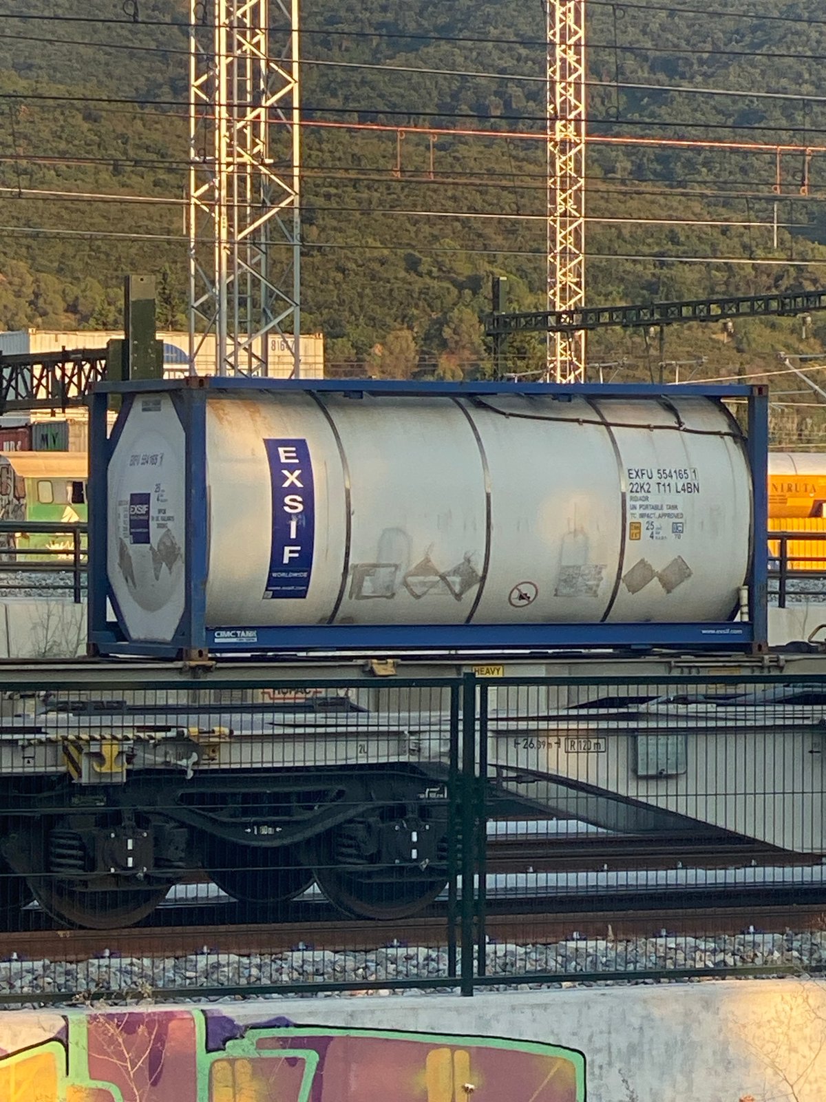 Commuter and freight trains pass through La Llagosta station