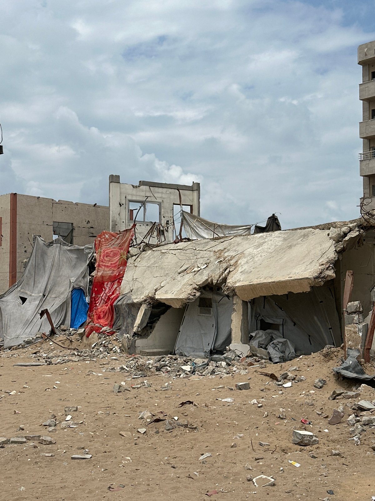 Children carry water, supplies amid Gaza rubble and tents