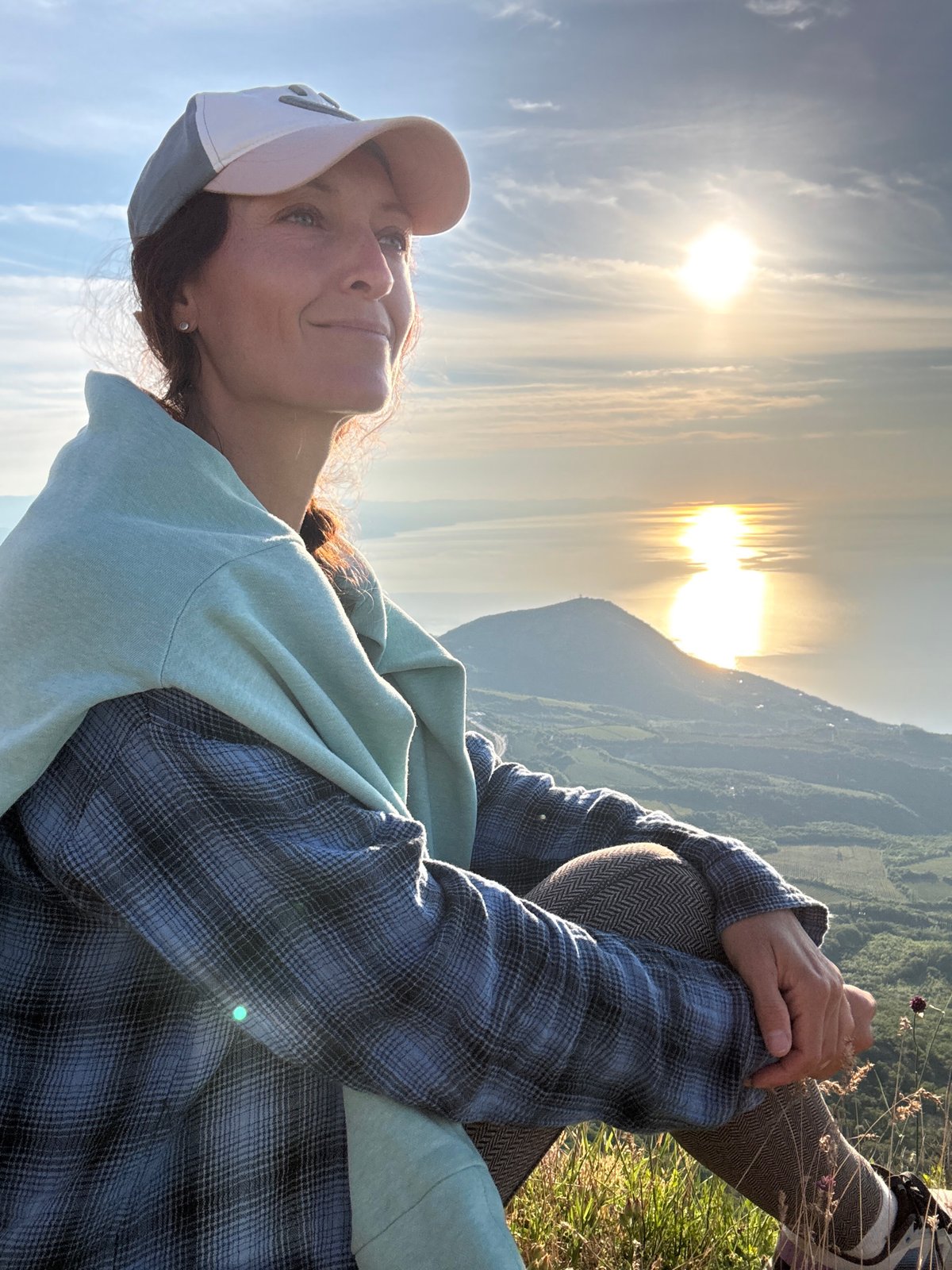 Woman photographed at multiple scenic overlooks during golden hour