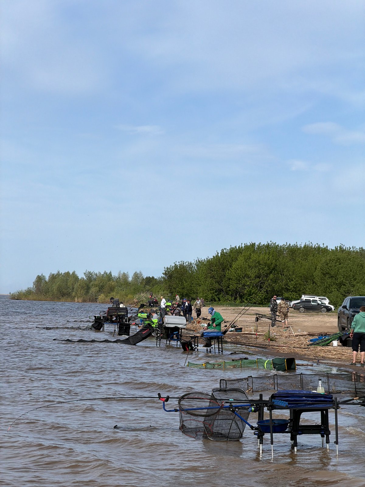 Early morning fishing group gathers at Krasnyi Bor lakeside