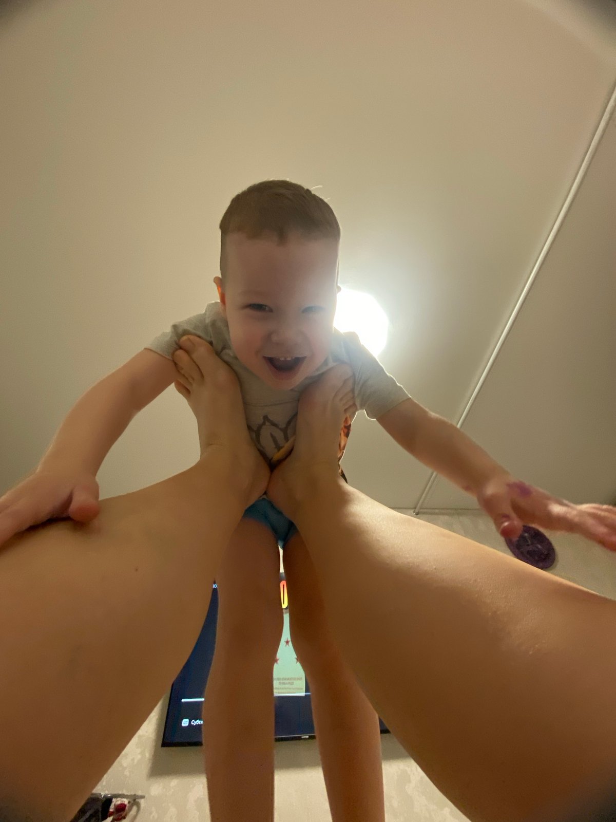 Toddler enjoys playful moment with adult in Sochi